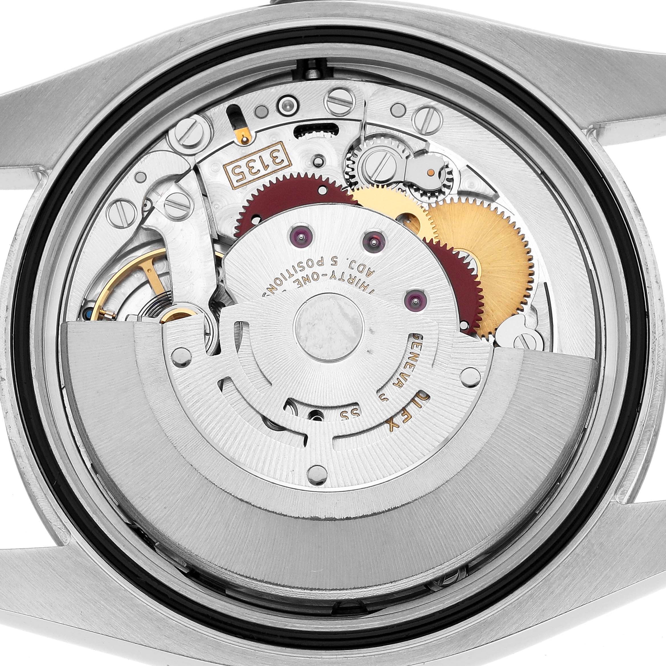 The image shows the movement of a Rolex Datejust 116234 Men's Stainless Steel Pink Dial, focusing on gears and components from the back.
