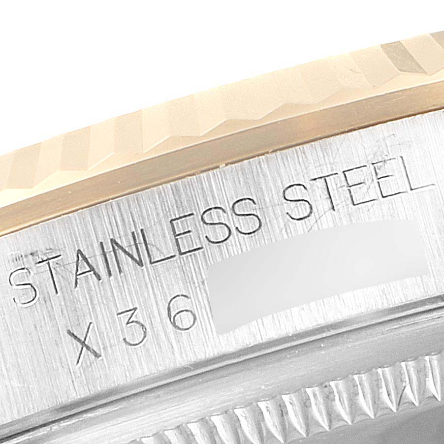 This close-up image shows the side of the case and part of the bezel of a Rolex Datejust 16233 Men's Steel and Gold (two tone) Black Dial 16233 Men's Steel and Gold (two tone) Black Dial watch.