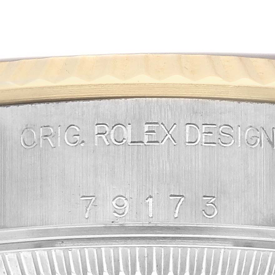 The image shows a close-up of the case edge with "ORIG. ROLEX DESIGN" and numbers for the Rolex Datejust 79173 Women's Steel and Gold (two tone) Champagne Dial.