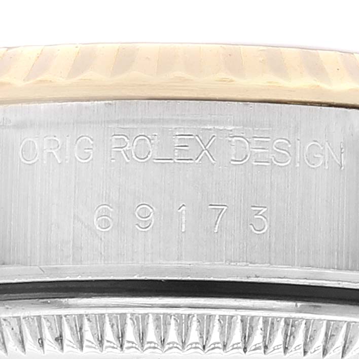 This image shows the side of a Rolex Datejust 69173 Women's Steel and Gold (two tone) Black Dial 69173 Women's Steel and Gold (two tone) Black Dial watch, focusing on the bezel, case, and model number inscription.