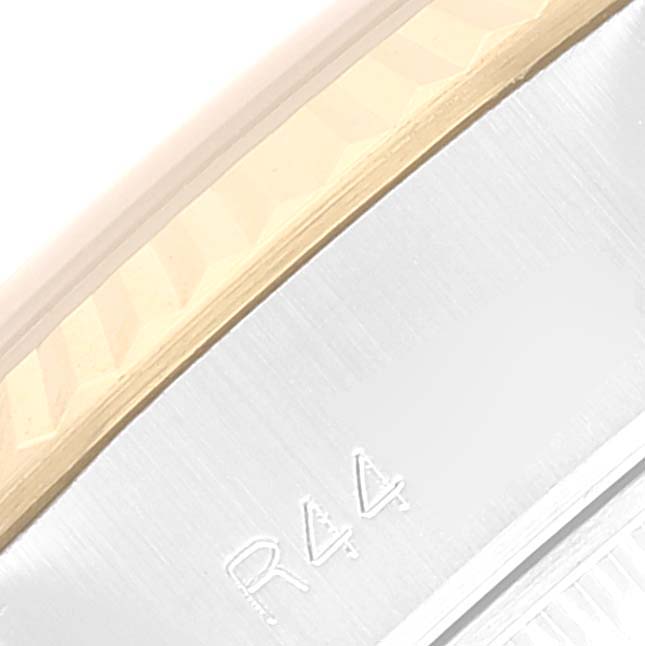 This image shows a close-up of the bezel and case side of a Rolex Datejust 69173 Women's Steel and Gold (two tone) Champagne Dial 69173 Women's Steel and Gold (two tone) Champagne Dial watch, displaying part of its serial number.