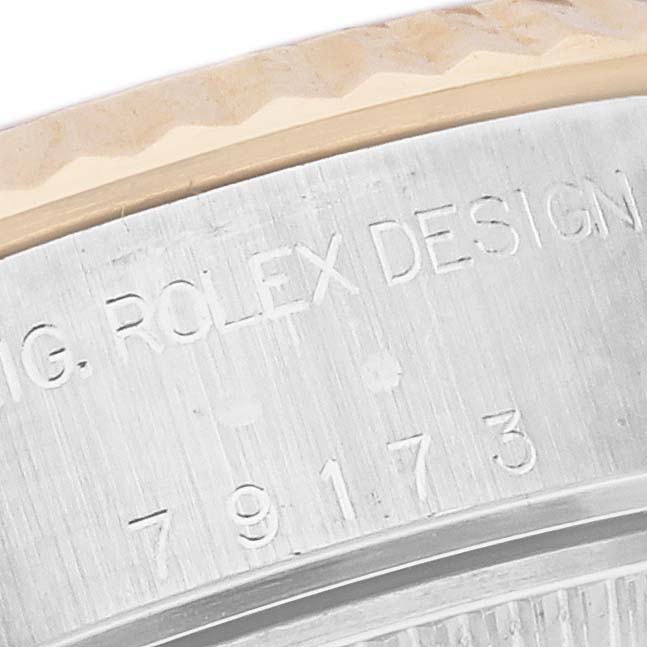 This close-up angle shows the engraved bezel and case of a Rolex Datejust 79173 Women's Steel and Gold (two tone) Grey Dial 79173 Women's Steel and Gold (two tone) Grey Dial watch.