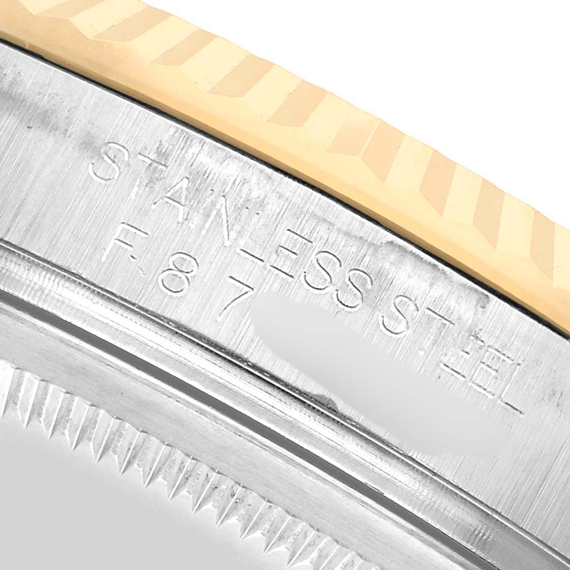 The image shows a close-up of the engraved inner bezel of a Rolex Datejust 116233 Men's Steel and Gold (two tone) White Dial watch, highlighting the material and details.