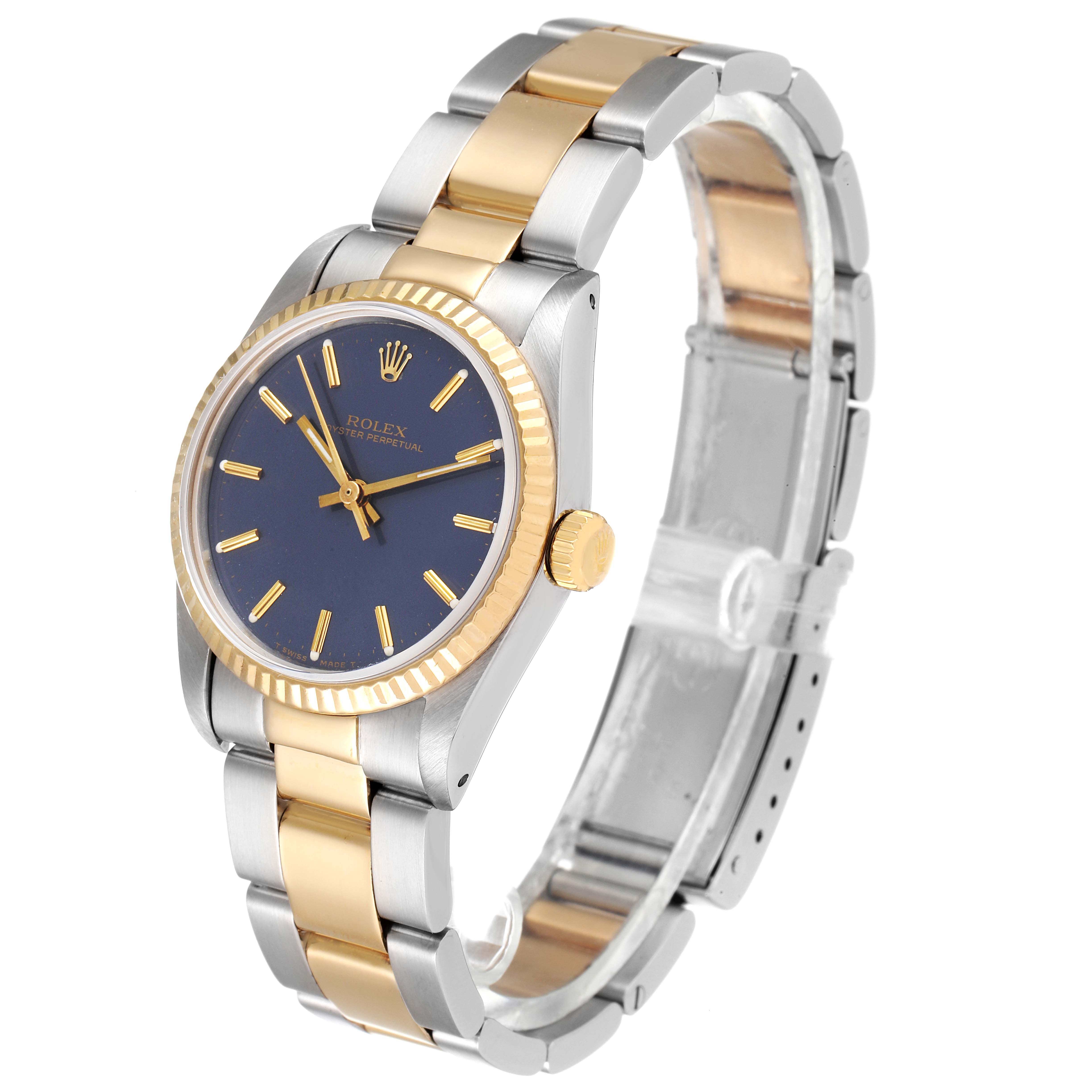 The image shows a Rolex Mid-Size 67513 Women's Steel and Gold (two tone) Blue Dial 67513 Women's Steel and Gold (two tone) Blue Dial watch from an angled side, highlighting its bi-metal bracelet, blue dial, and gold bezel.