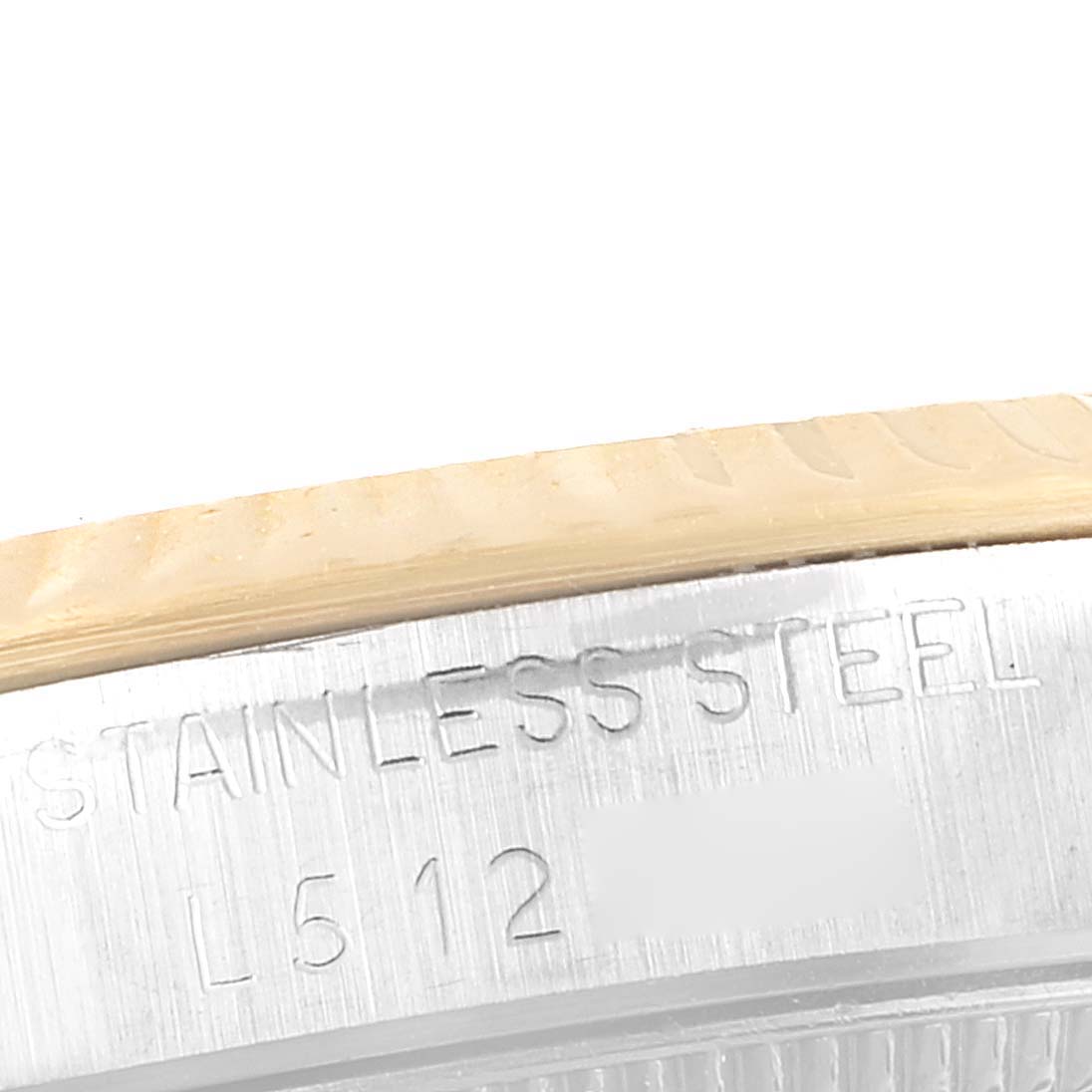The image shows the side engraving "Stainless Steel" on the casing of a mid-size Rolex watch.