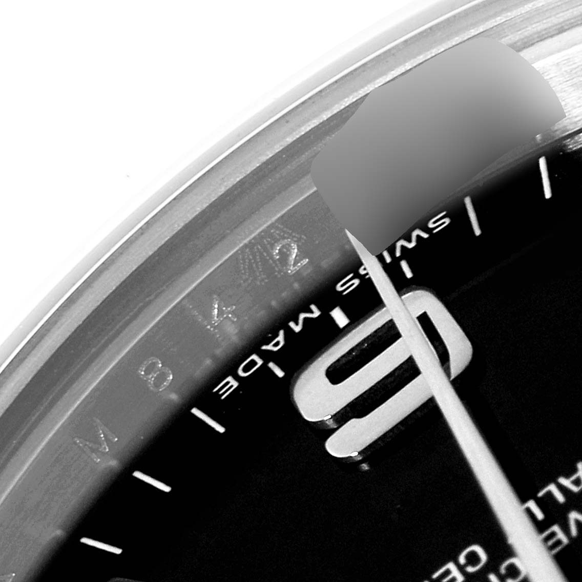 The image shows a close-up of the dial and bezel of the Mid-Size Rolex watch, focusing on the "Swiss Made" text and part of the hour markers.