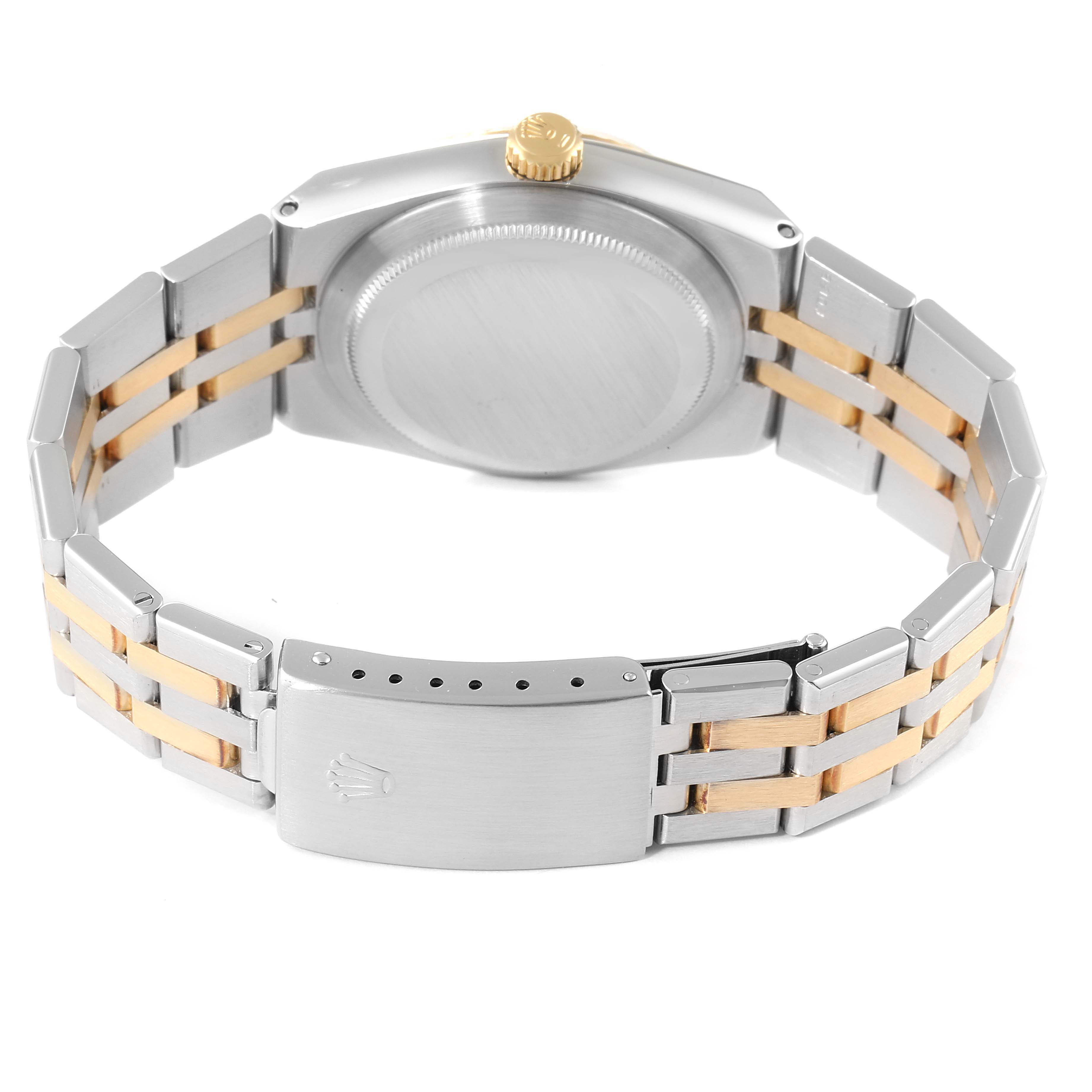 The Rolex Oysterquartz 17013 Men's Steel and Gold (two tone) Champagne Dial 17013 Men's Steel and Gold (two tone) Champagne Dial watch is shown from the back, displaying its case, gold crown, and two-tone bracelet.