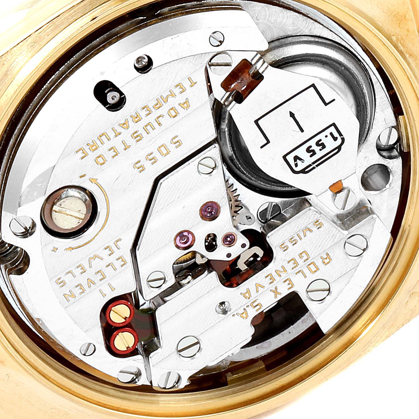 The image shows a close-up view of the movement of a Rolex Oysterquartz 19018 Men's Yellow Gold Champagne Dial 19018 Men's Yellow Gold Champagne Dial watch, revealing intricate components and engravings.