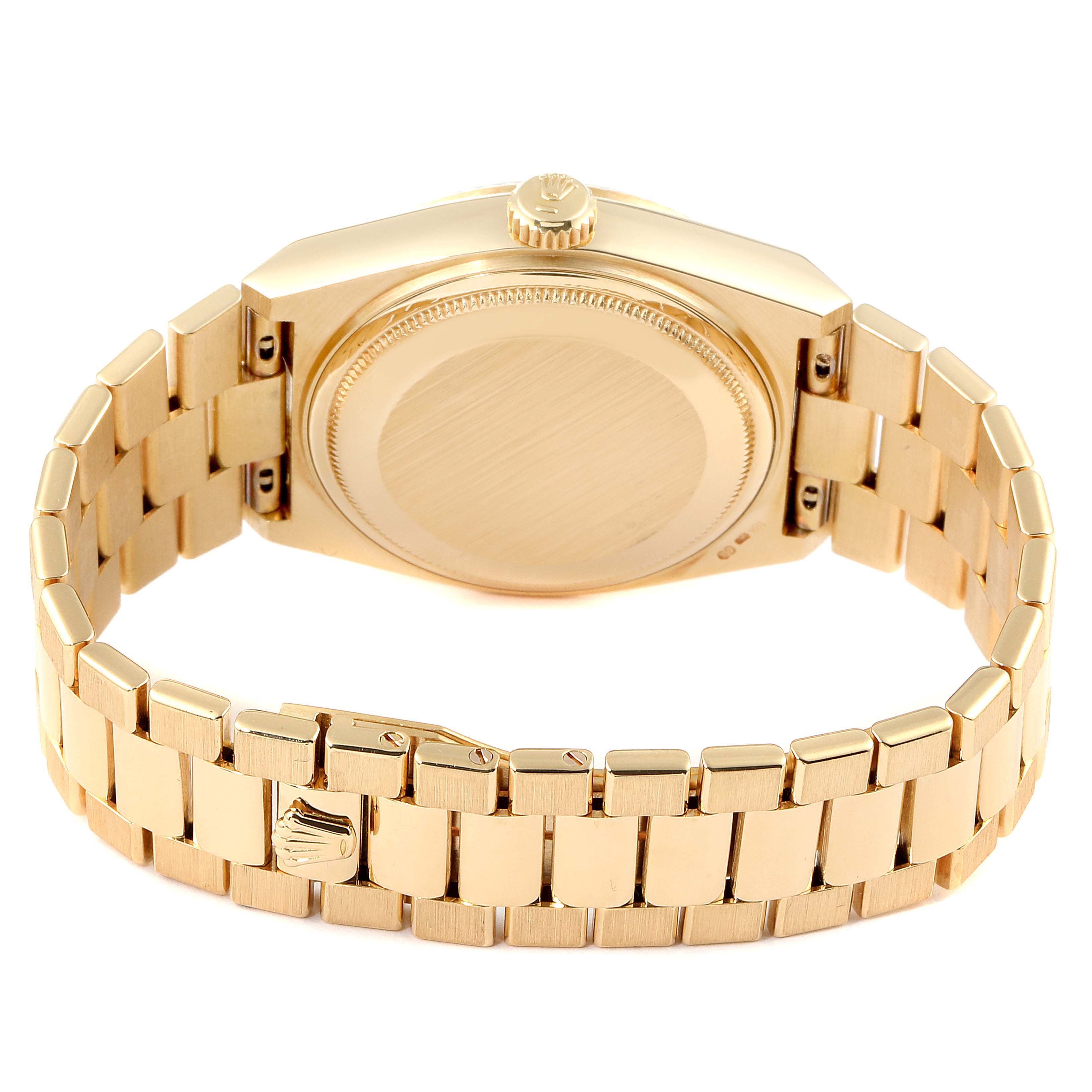 This Rolex Oysterquartz 19018 Men's Yellow Gold Champagne Dial 19018 Men's Yellow Gold Champagne Dial watch is shown from the back, highlighting the case back, crown, and metal bracelet.