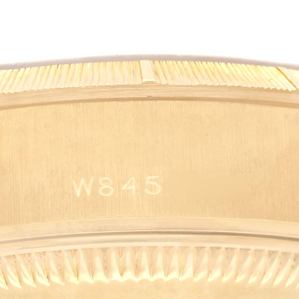 The image shows a close-up of the side engraving and fluted bezel of a Rolex President 69278 Women's Yellow Gold Champagne Dial 69278 Women's Yellow Gold Champagne Dial watch.