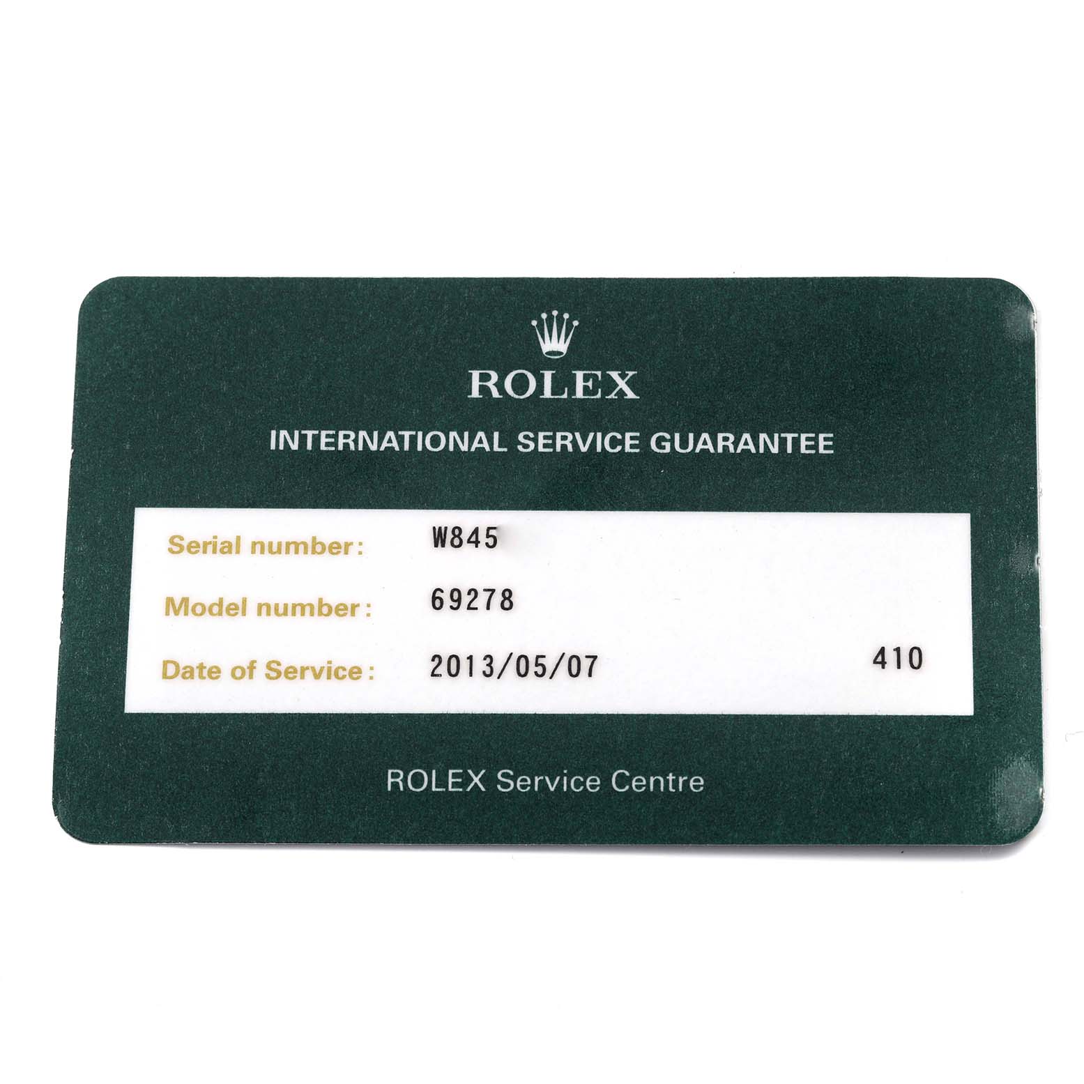 The image shows a Rolex International Service Guarantee card for the President model, detailing serial and service information.