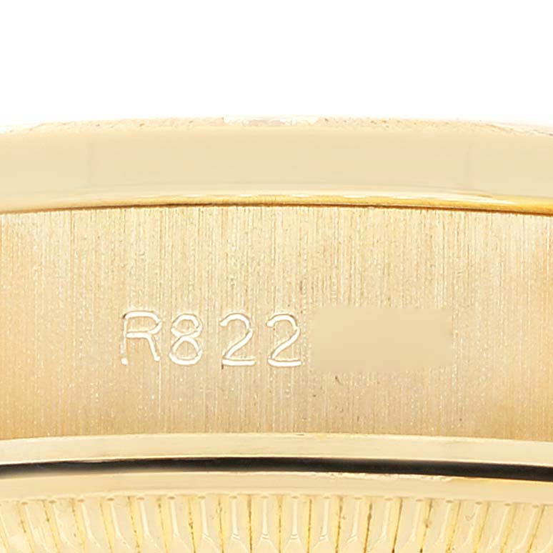This image shows a close-up of the side of a Rolex President 69288 Women
s Yellow Gold Champagne Dial 69288 Women
s Yellow Gold Champagne Dial model watch, focusing on the engraved serial number.