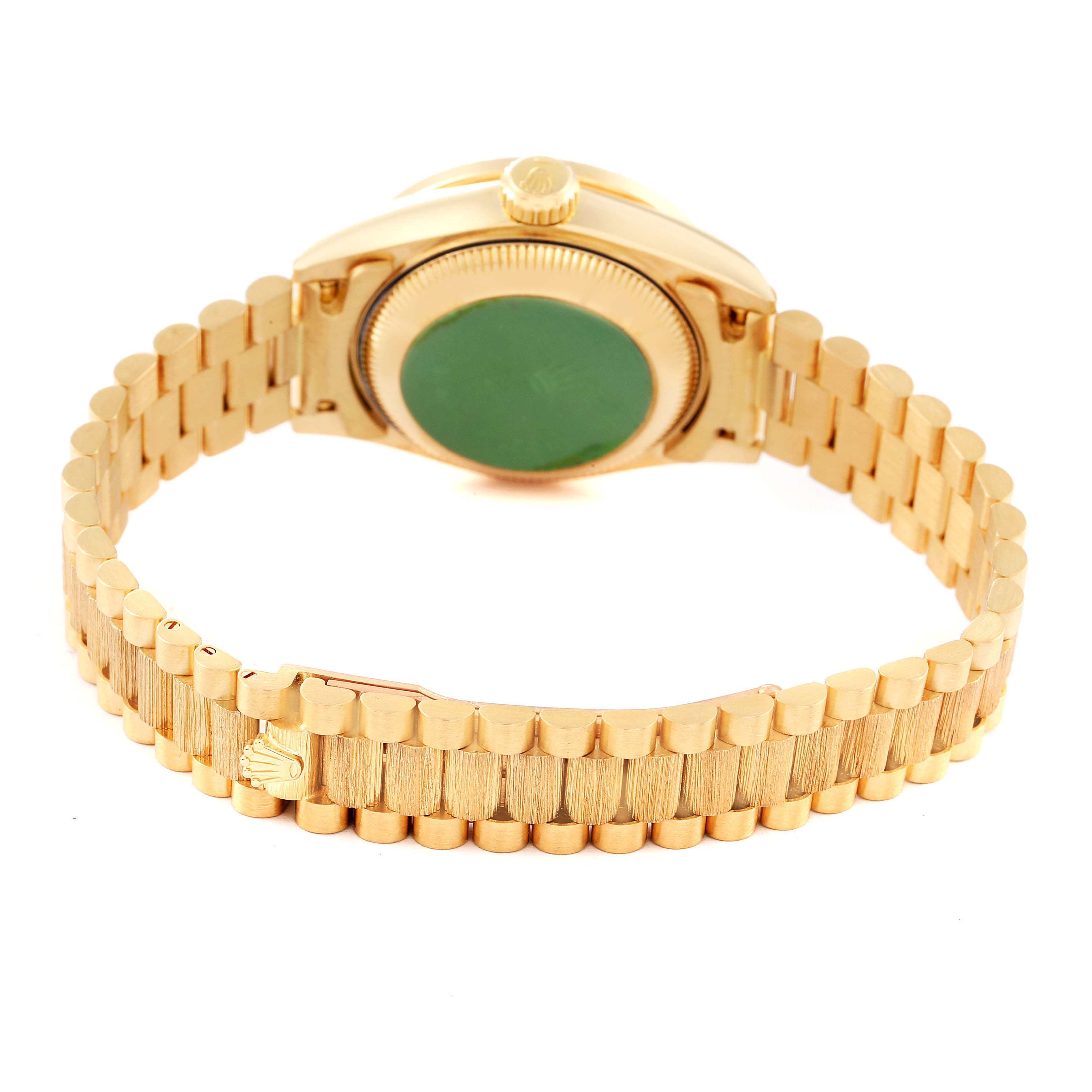 The image shows the back view of a Rolex President 69288 Women
s Yellow Gold Champagne Dial 69288 Women
s Yellow Gold Champagne Dial model watch, highlighting its gold bracelet and case back.