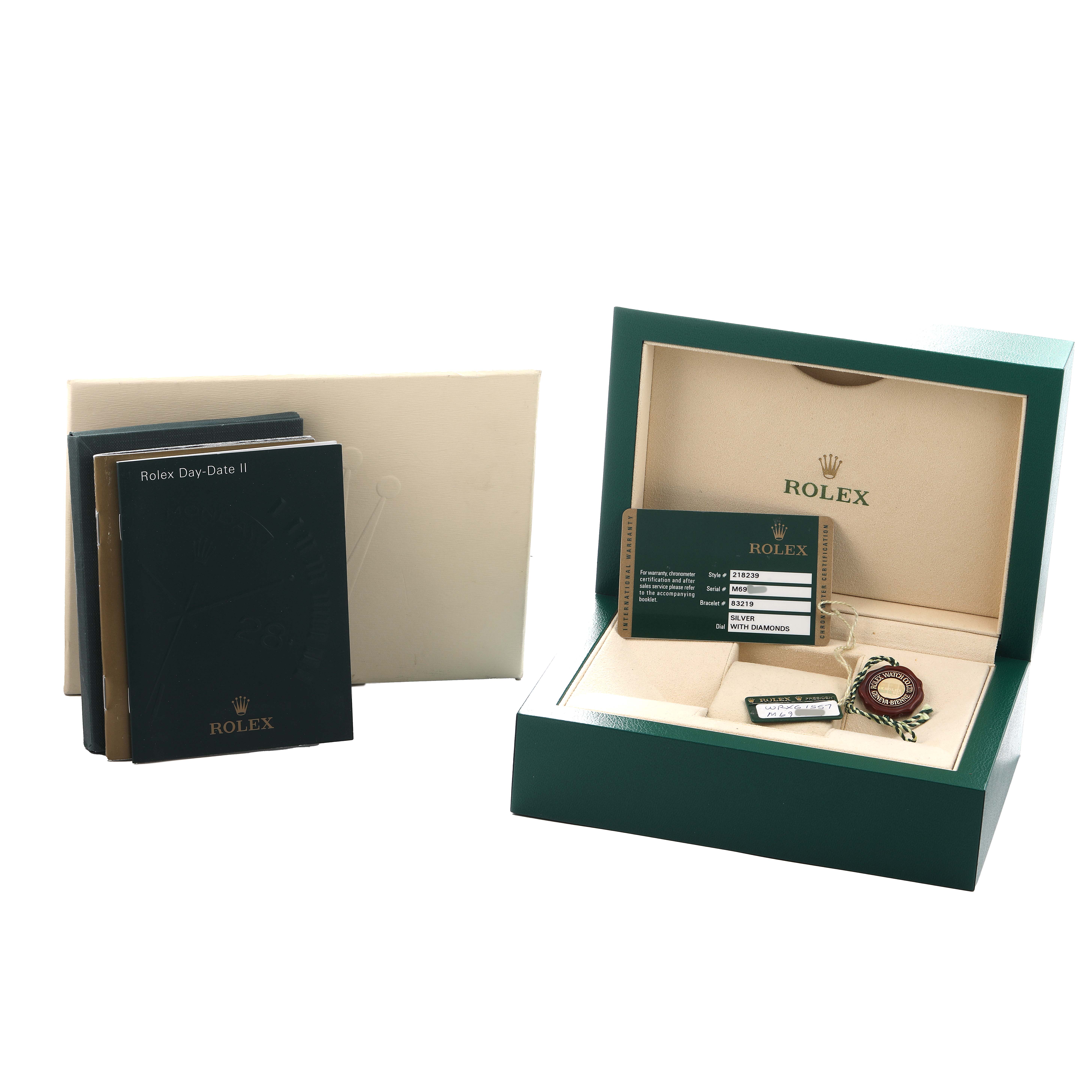 The image shows the packaging and accessories of a Rolex President 218239 Men's White Gold Silver Dial model, including manuals, a box, tag, card, and medallion, from a top angle.