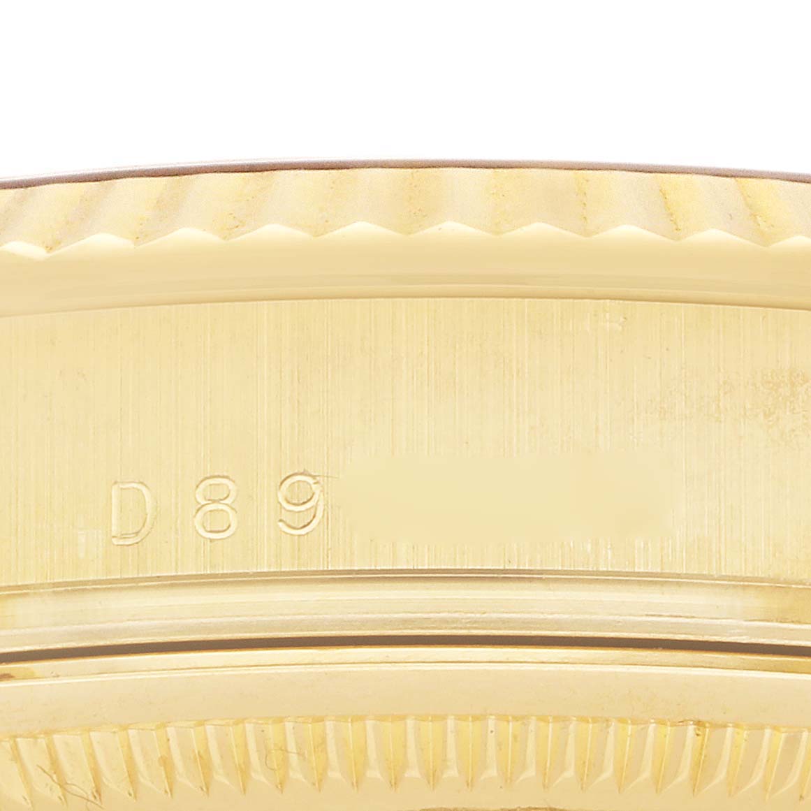 The image shows a close-up view of the serrated edge and serial number of a Rolex President 118238 Men's Yellow Gold Black Dial model watch case.