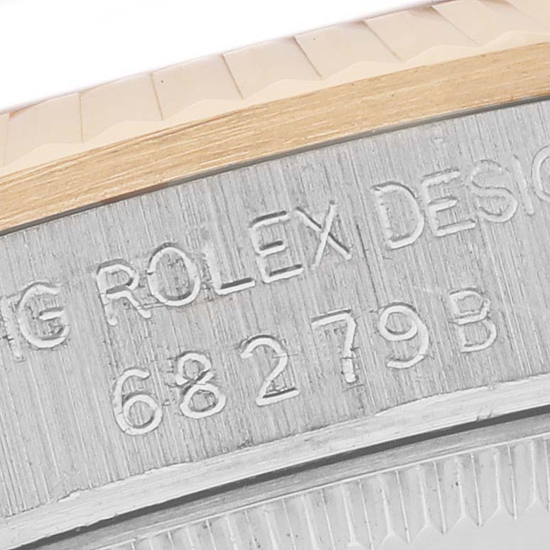 The image shows a close-up of the engraved edge and serial number of a Rolex President 68279B Women's White Gold Champagne Dial 68279B Women's White Gold Champagne Dial model watch.
