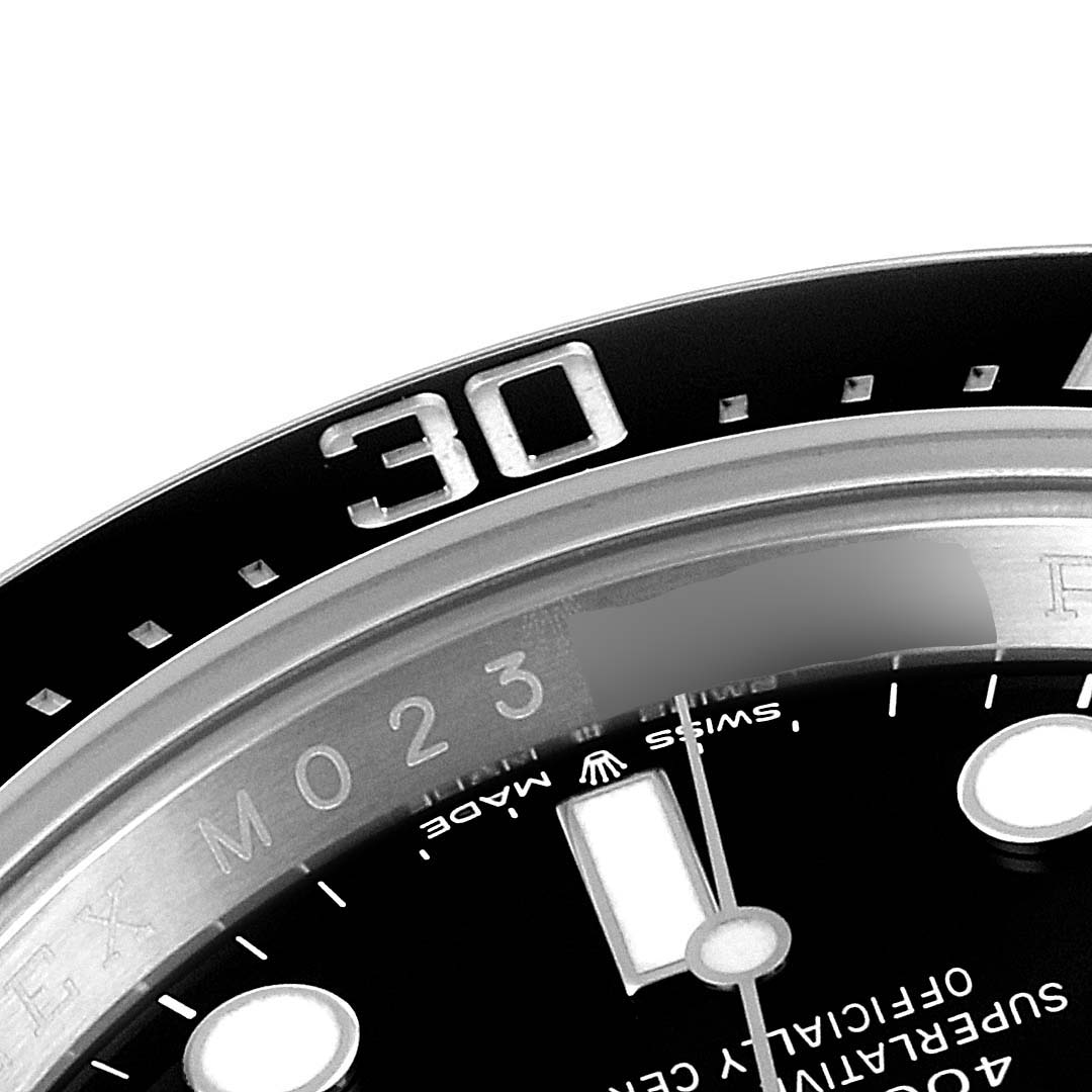 The image shows a close-up of the bezel, part of the dial, and part of the text on a Rolex Sea-Dweller 126600 Men
s Stainless Steel Black Dial 126600 Men
s Stainless Steel Black Dial watch.