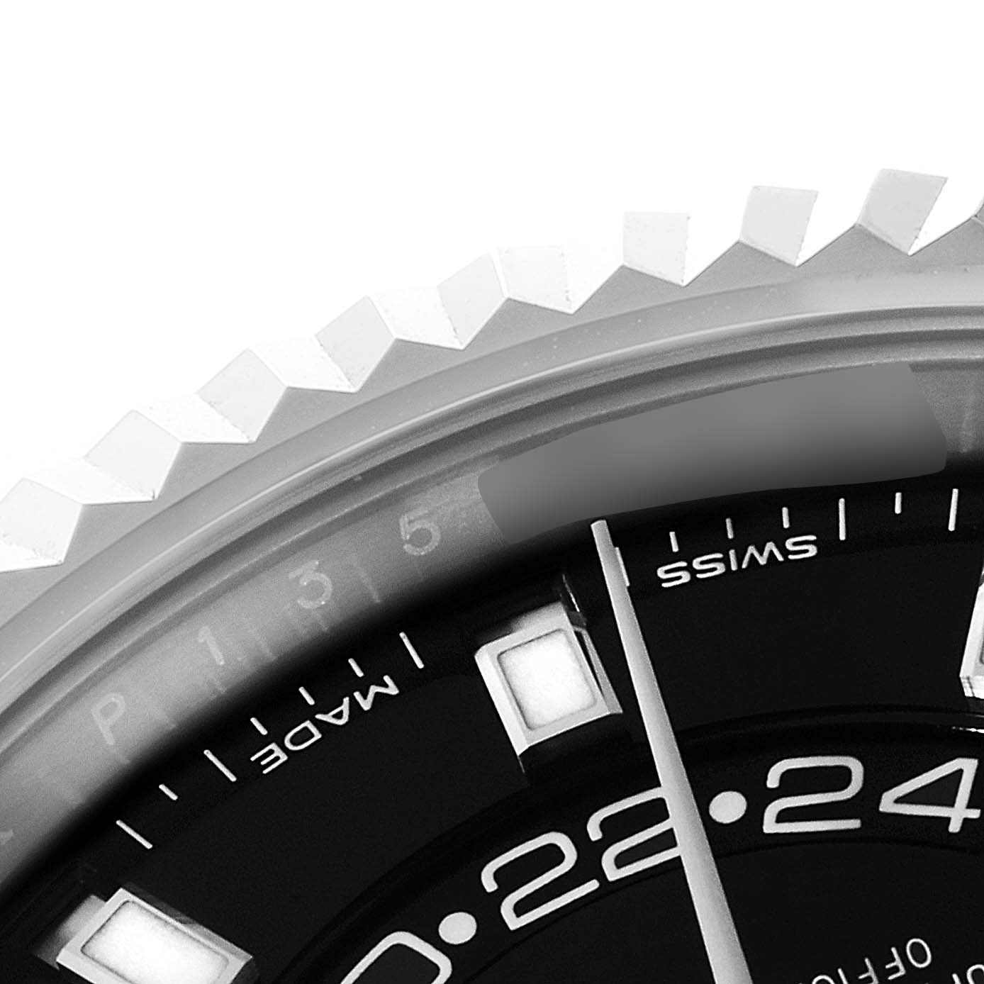 This image shows a close-up view of the bezel and part of the dial of a Rolex Sky-Dweller 326934 Men's Stainless Steel Black Dial 326934 Men's Stainless Steel Black Dial watch.