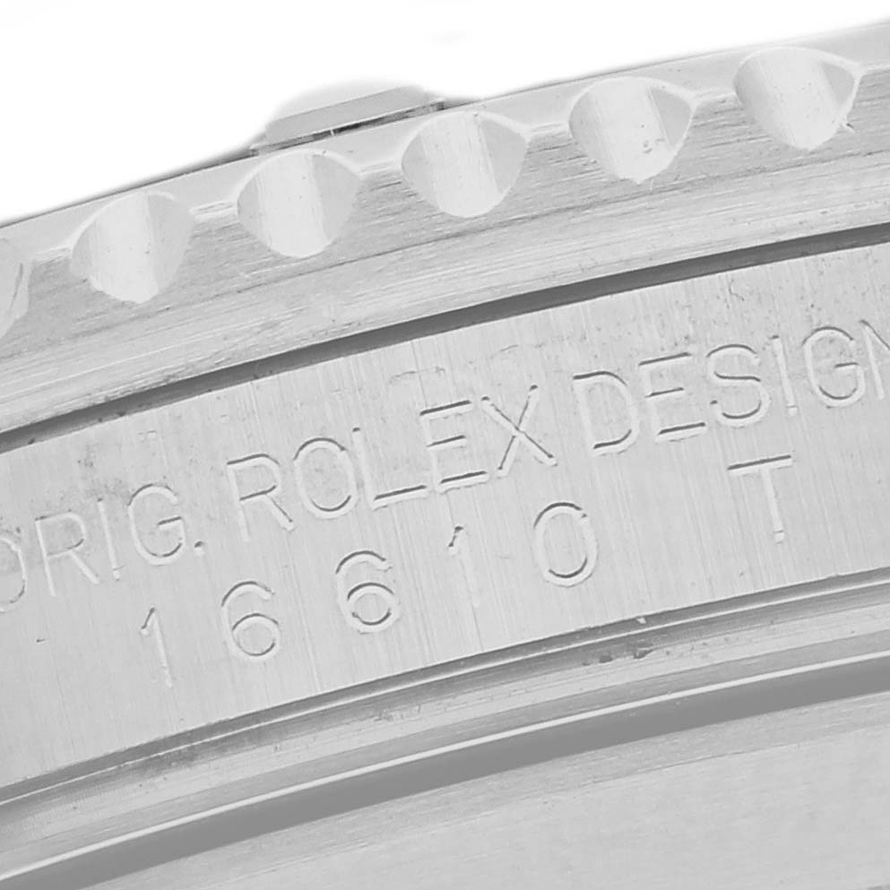 The image shows a close-up of the Rolex Submariner 16610 Men
s Stainless Steel Black Dial 16610 Men
s Stainless Steel Black Dial
s engraved side, displaying model details and part of the bezel.