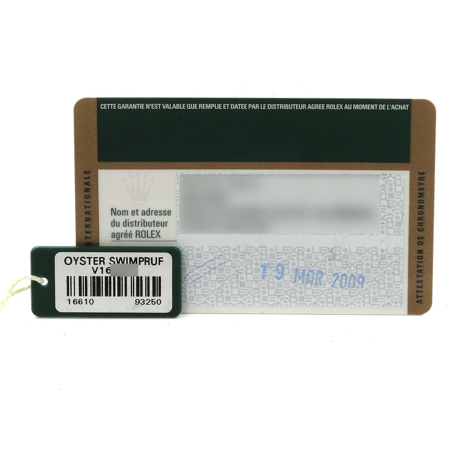 The image shows a Rolex Submariner 16610 Men
s Stainless Steel Black Dial 16610 Men
s Stainless Steel Black Dial warranty card and a tag with model and serial numbers.