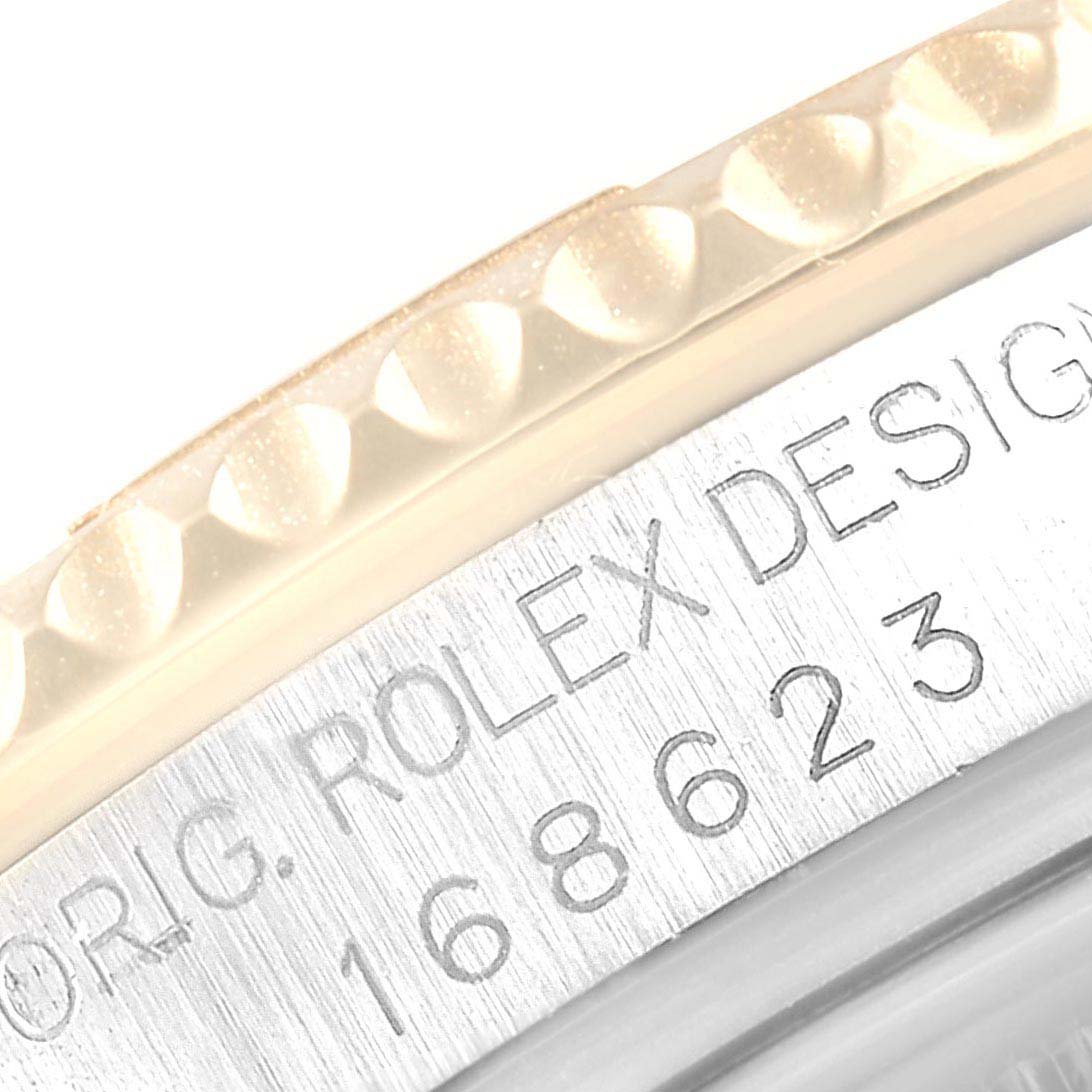 This is a close-up of the bezel and case of a Rolex Yacht-Master 168623 Men's Steel and Gold (two tone) White Dial 168623 Men's Steel and Gold (two tone) White Dial watch, showing the model number and "Rolex" engraving.