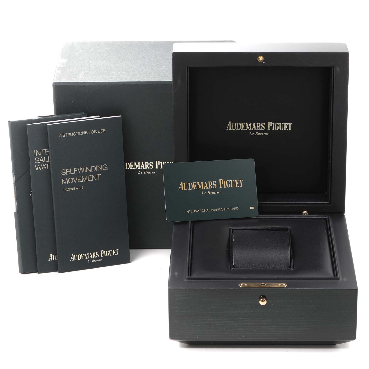 This image shows the packaging for a Royal Oak model by Audemars Piguet, with its box, manuals, and warranty card.