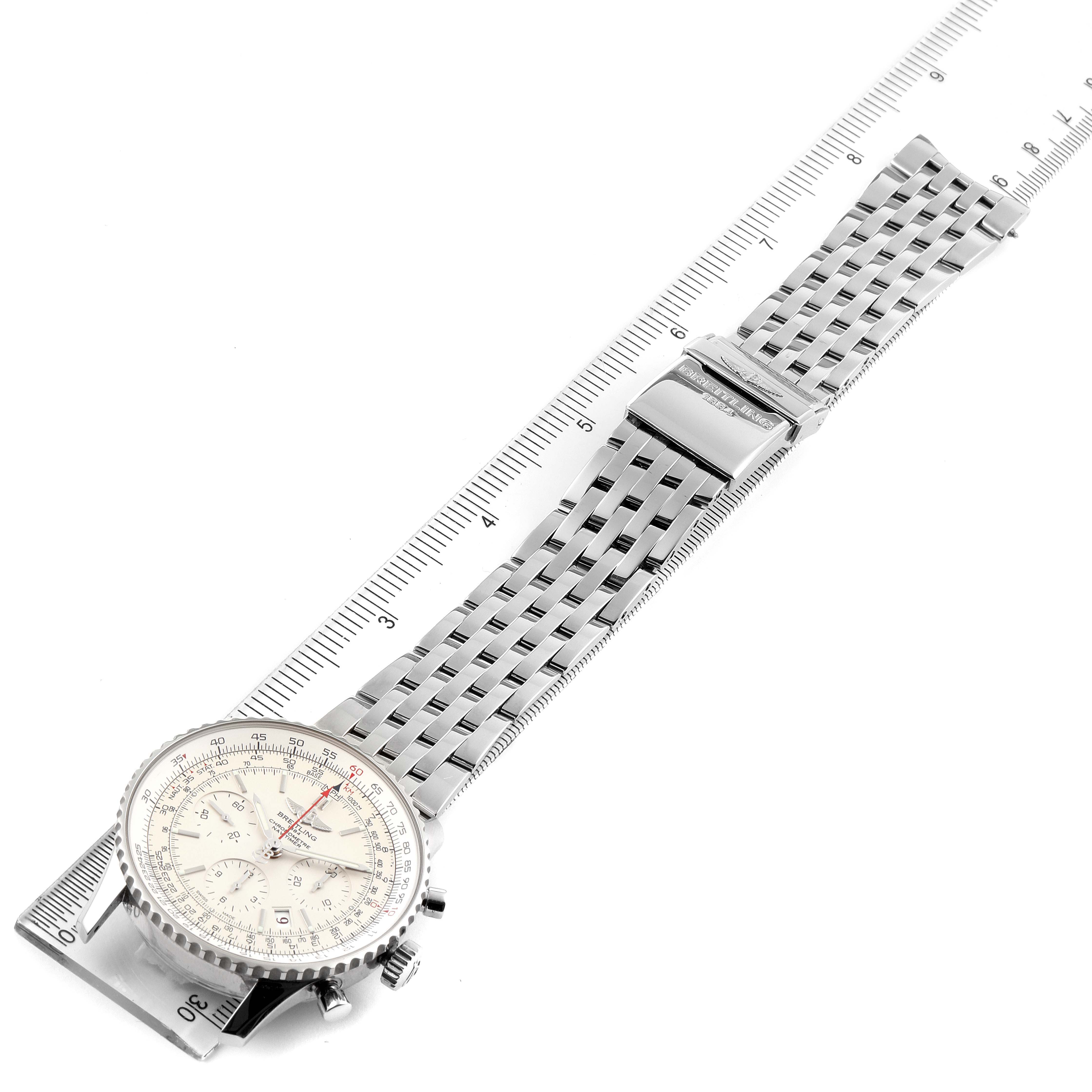 The image shows a top-down view of a Breitling Navitimer AB0123 Men's Stainless Steel Silver Dial AB0123 Men's Stainless Steel Silver Dial watch, highlighting its face and metal bracelet extended on a ruler.