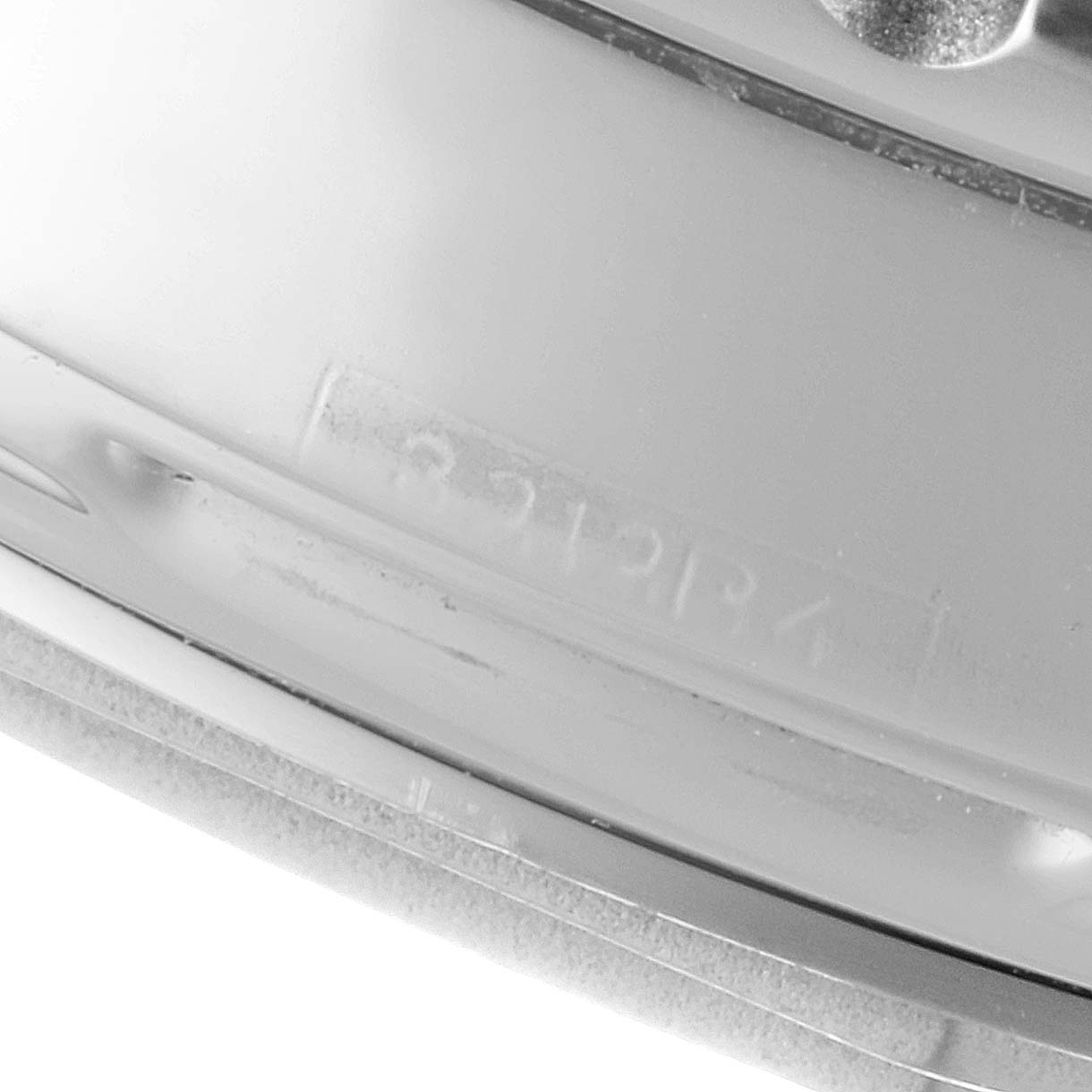 This image shows a close-up of the side of the Breitling Navitimer AB0123 Men's Stainless Steel Silver Dial AB0123 Men's Stainless Steel Silver Dial watch case, focusing on the engraved serial number.