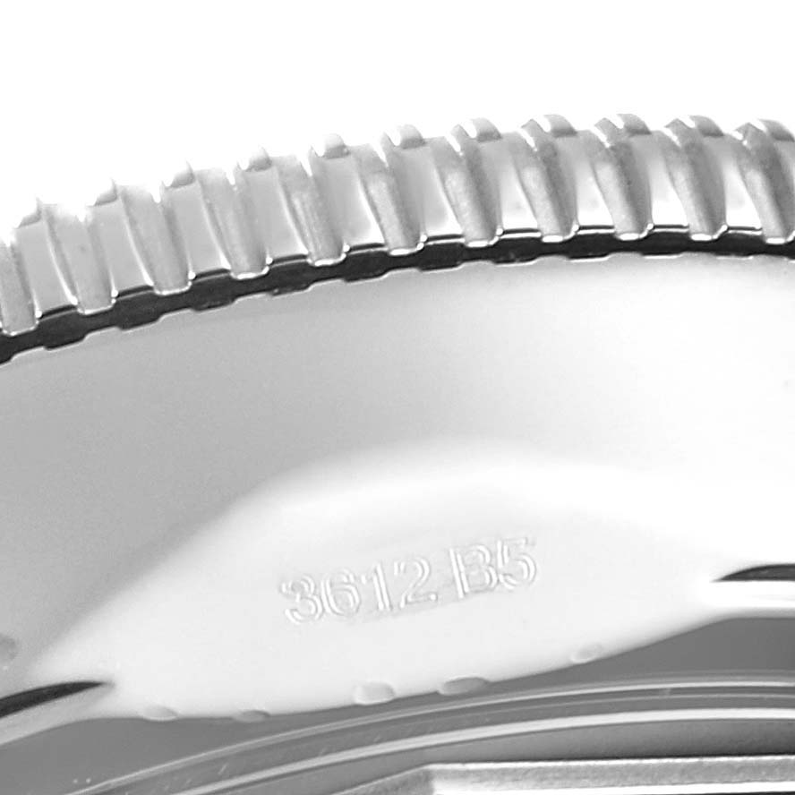 The image shows an extreme close-up of the bezel and case of a Breitling Superocean U23370 Men
s Steel and Gold (two tone) Black Dial U23370 Men
s Steel and Gold (two tone) Black Dial watch.