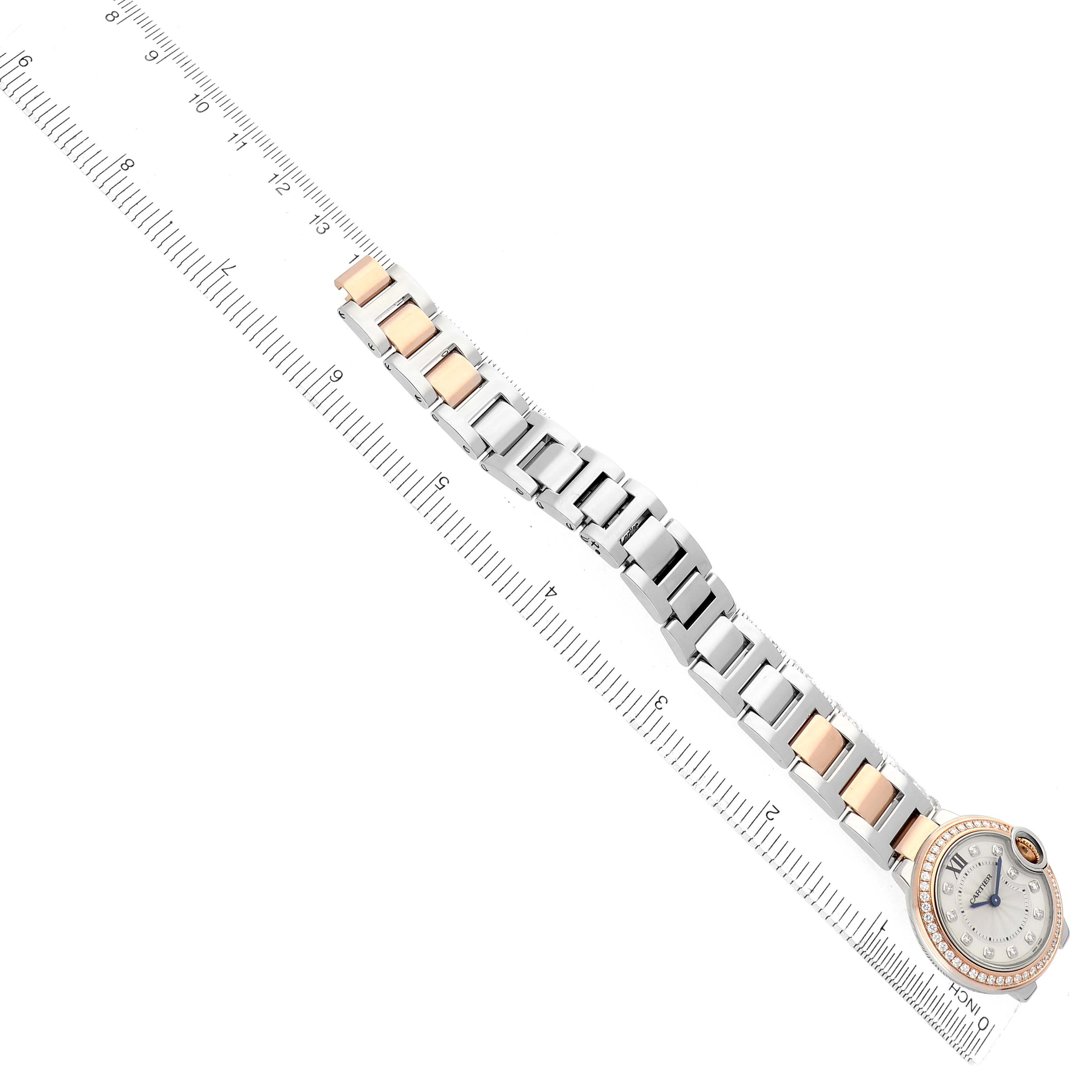 The Cartier Ballon Bleu W3BB0009 Women's Steel and Gold (two tone) Silver Dial watch is shown from an angled top view, displaying its bracelet and round face alongside a ruler for scale.