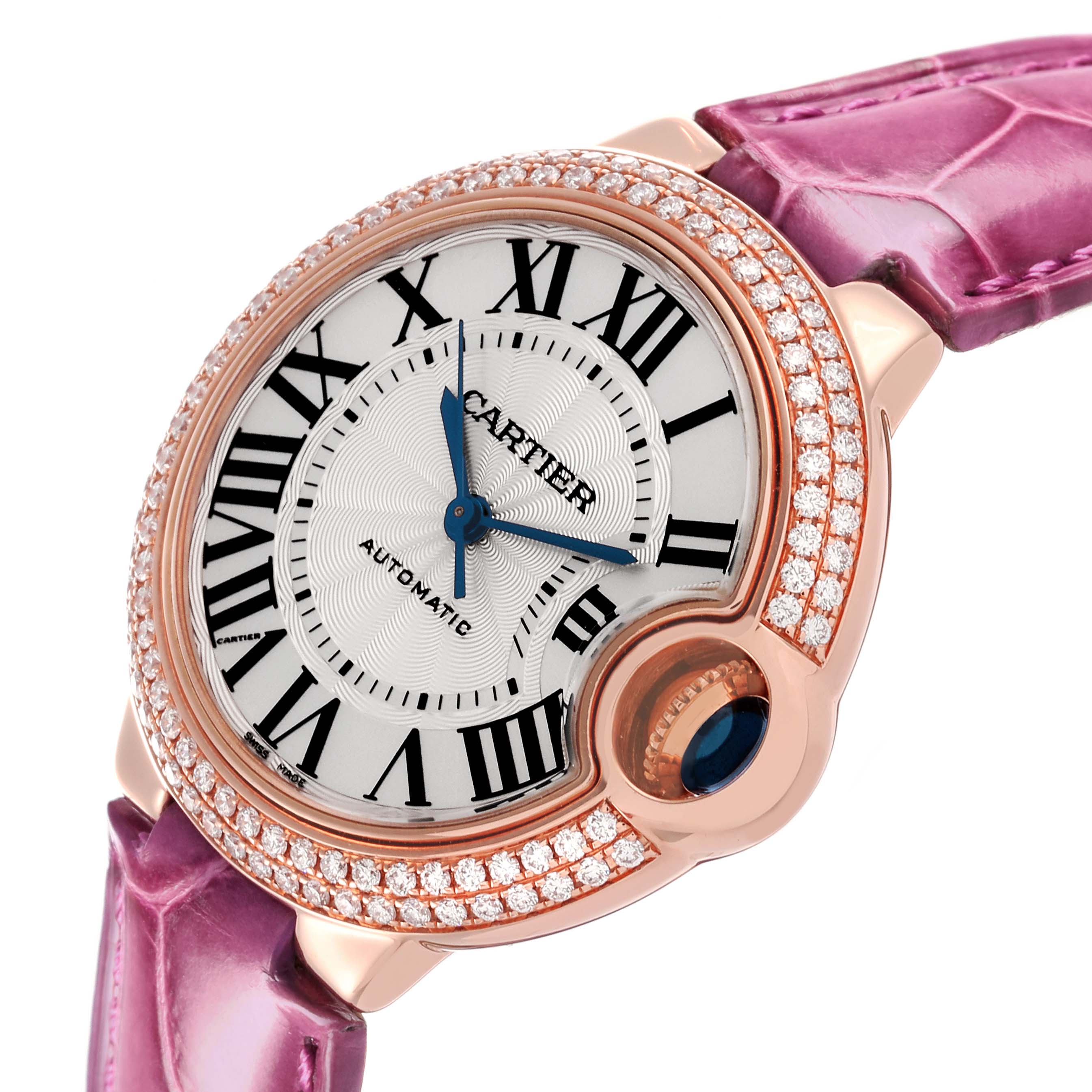 The Cartier Ballon Bleu WE902036 Women
s Rose Gold Silver Dial WE902036 Women
s Rose Gold Silver Dial watch is shown from an angled view, highlighting its diamond-studded bezel and purple strap.
