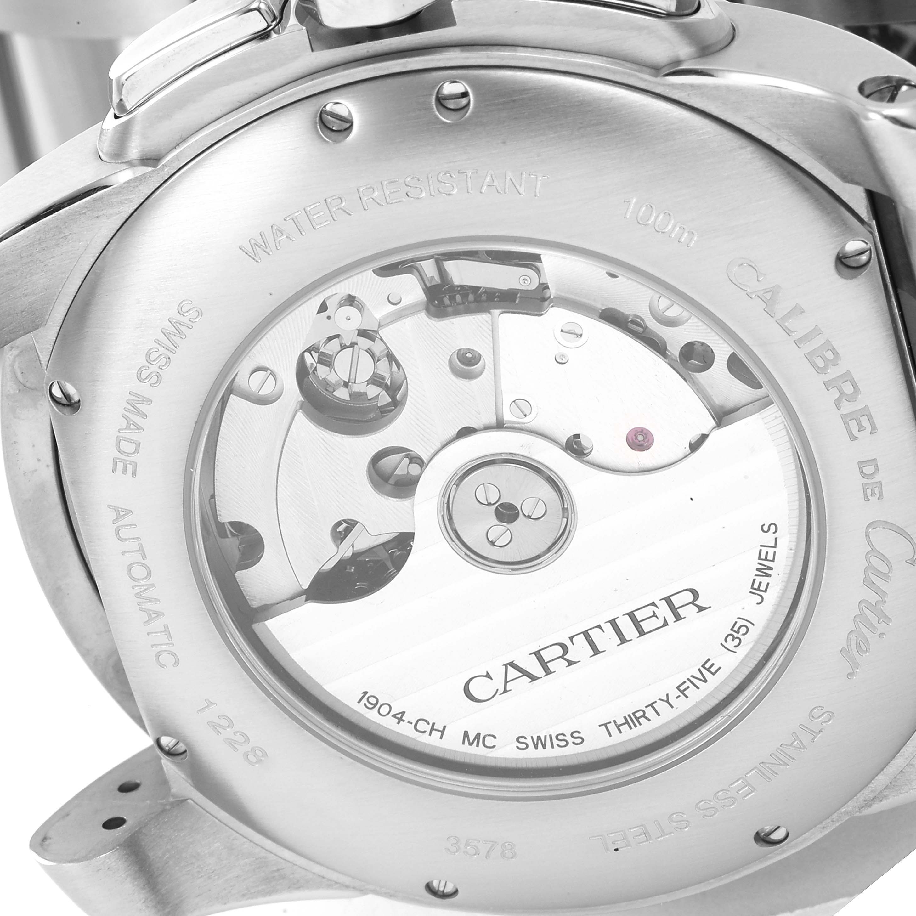 The image shows the back view of the Calibre de Cartier watch by Cartier, revealing its inner mechanisms and inscriptions.