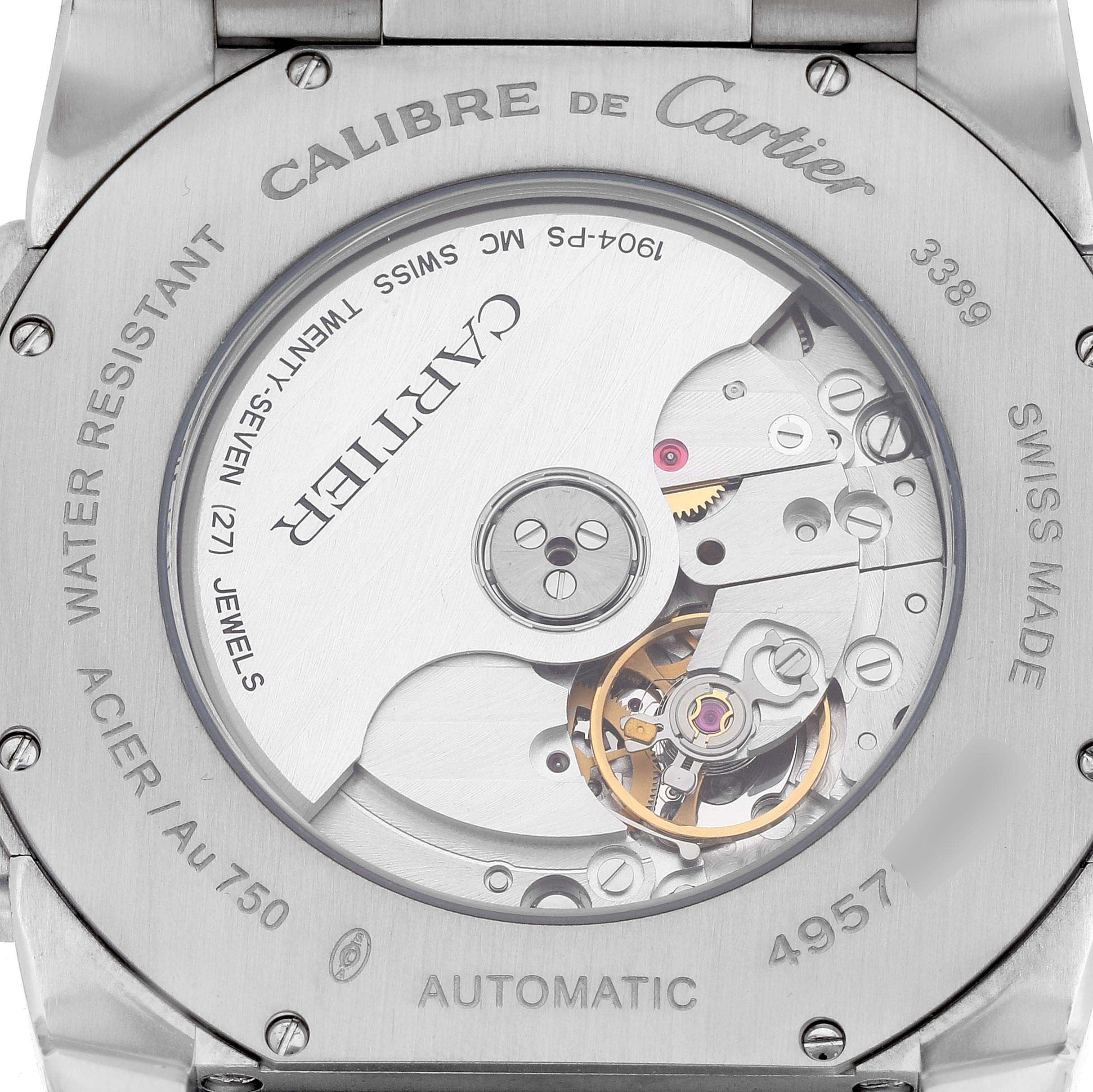 The image shows the back of a Calibre de Cartier watch by Cartier, displaying its automatic movement and inner mechanics.