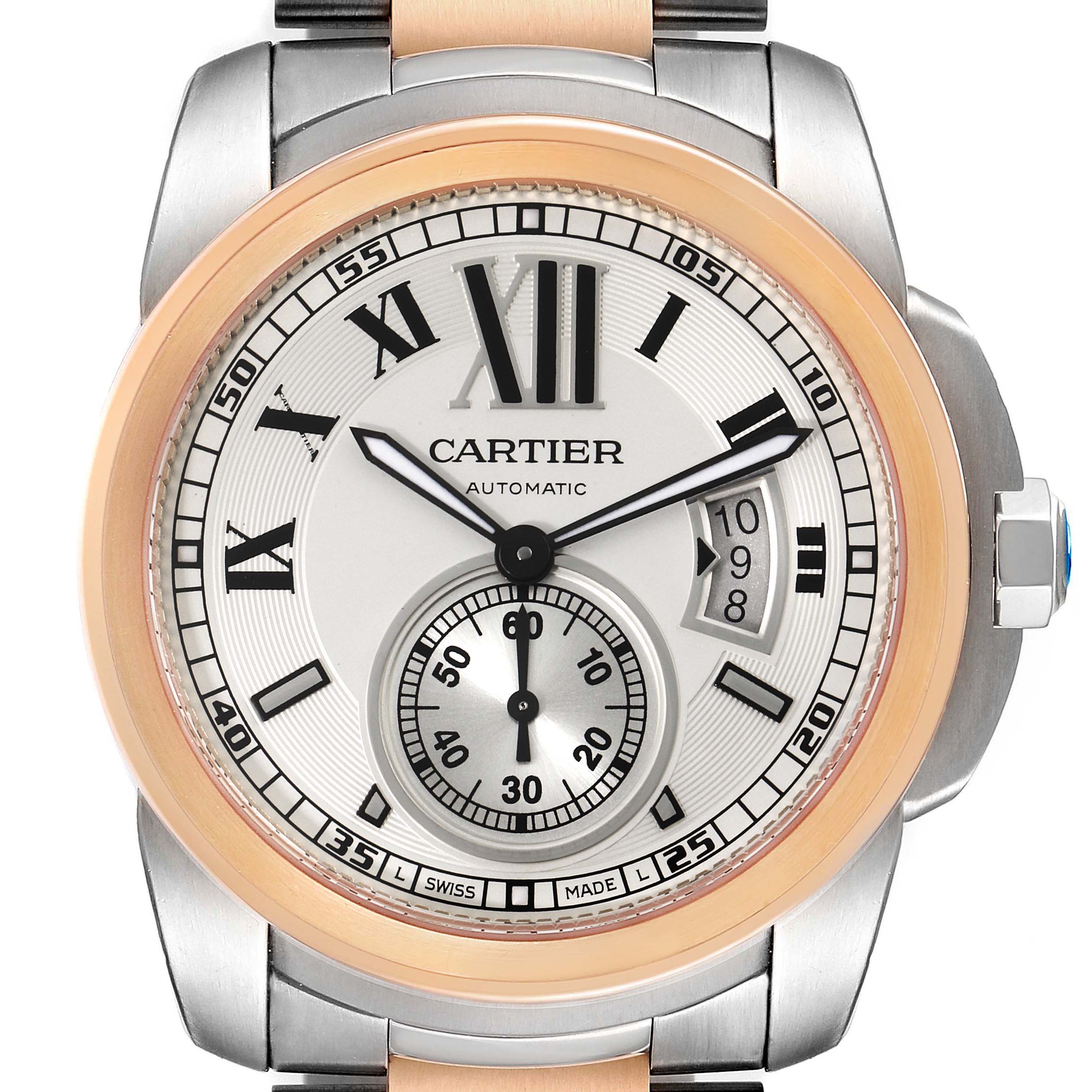This image shows the face and bezel of a Calibre de Cartier watch by Cartier, viewed from the front.