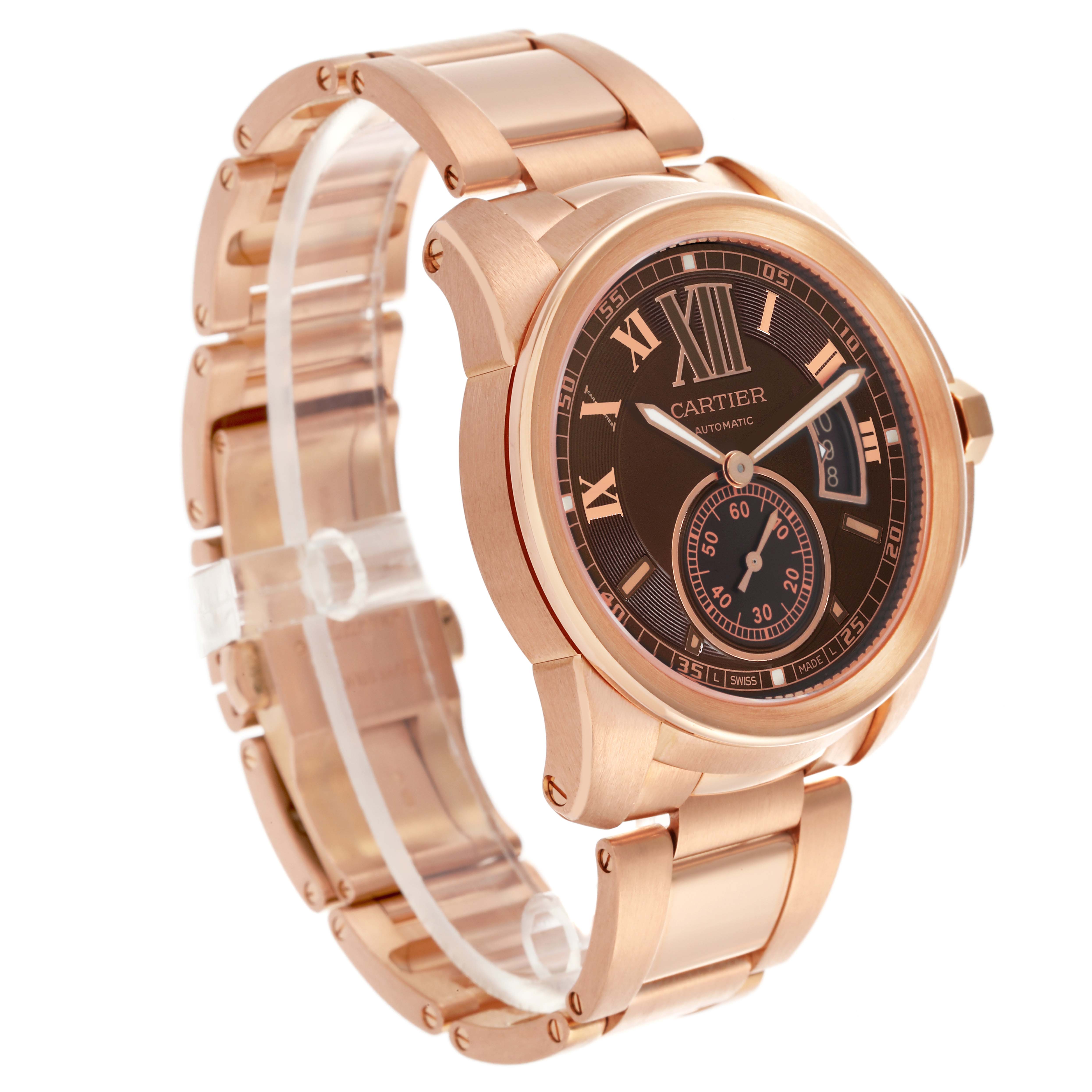 The Calibre de Cartier watch is shown at a three-quarter angle, highlighting its rose gold bracelet, case, and detailed dial.