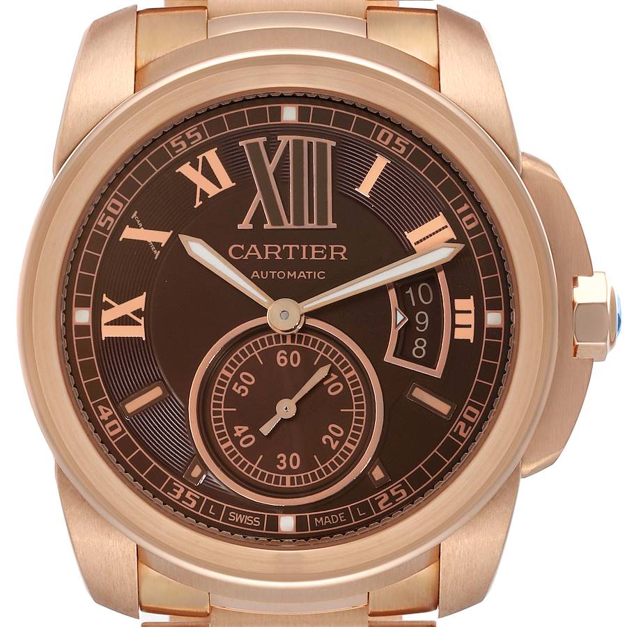 The watch face of the Calibre de Cartier is shown head-on, featuring the dial, hands, and calendar window.