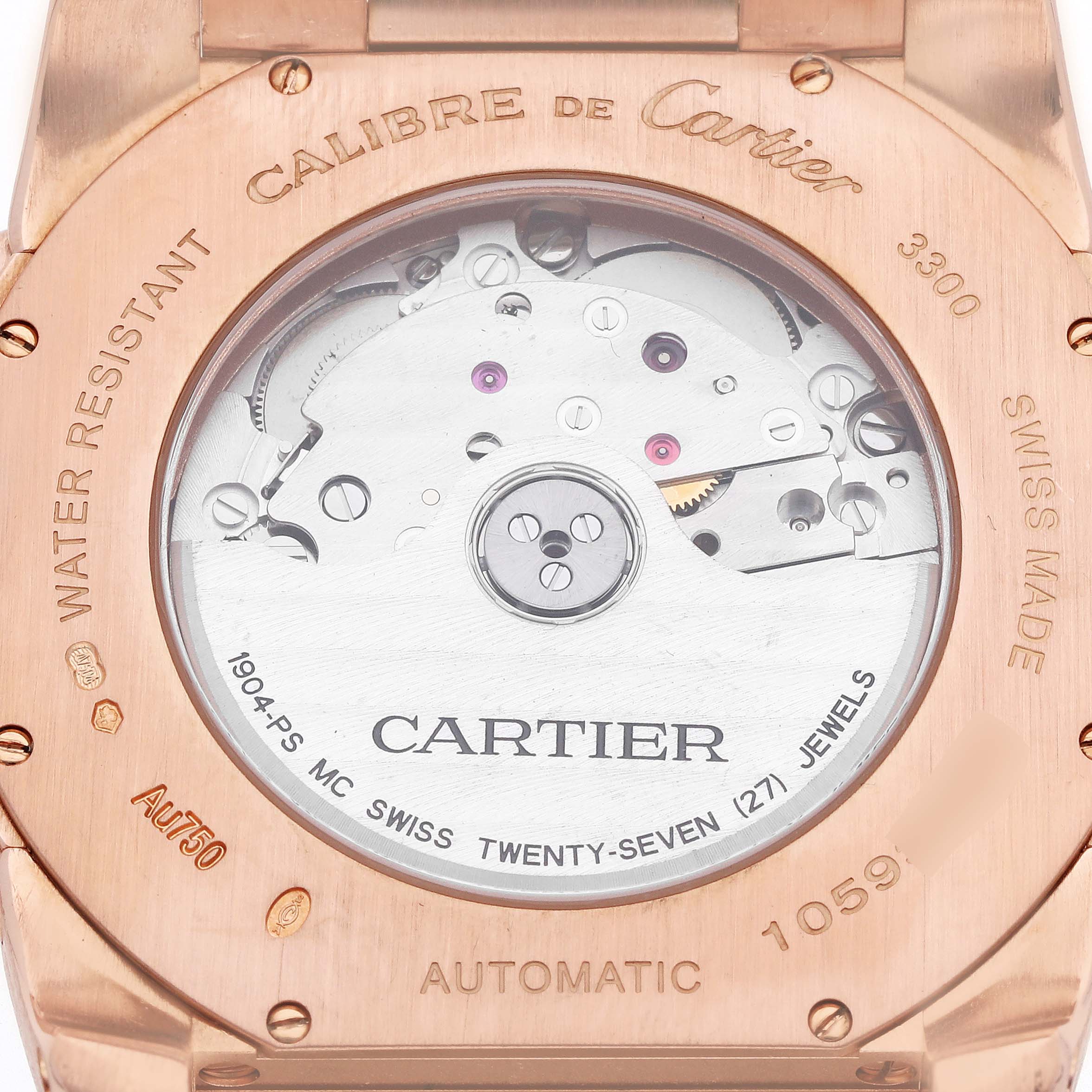 The image shows the case back of a Calibre de Cartier watch, revealing the movement and engravings.