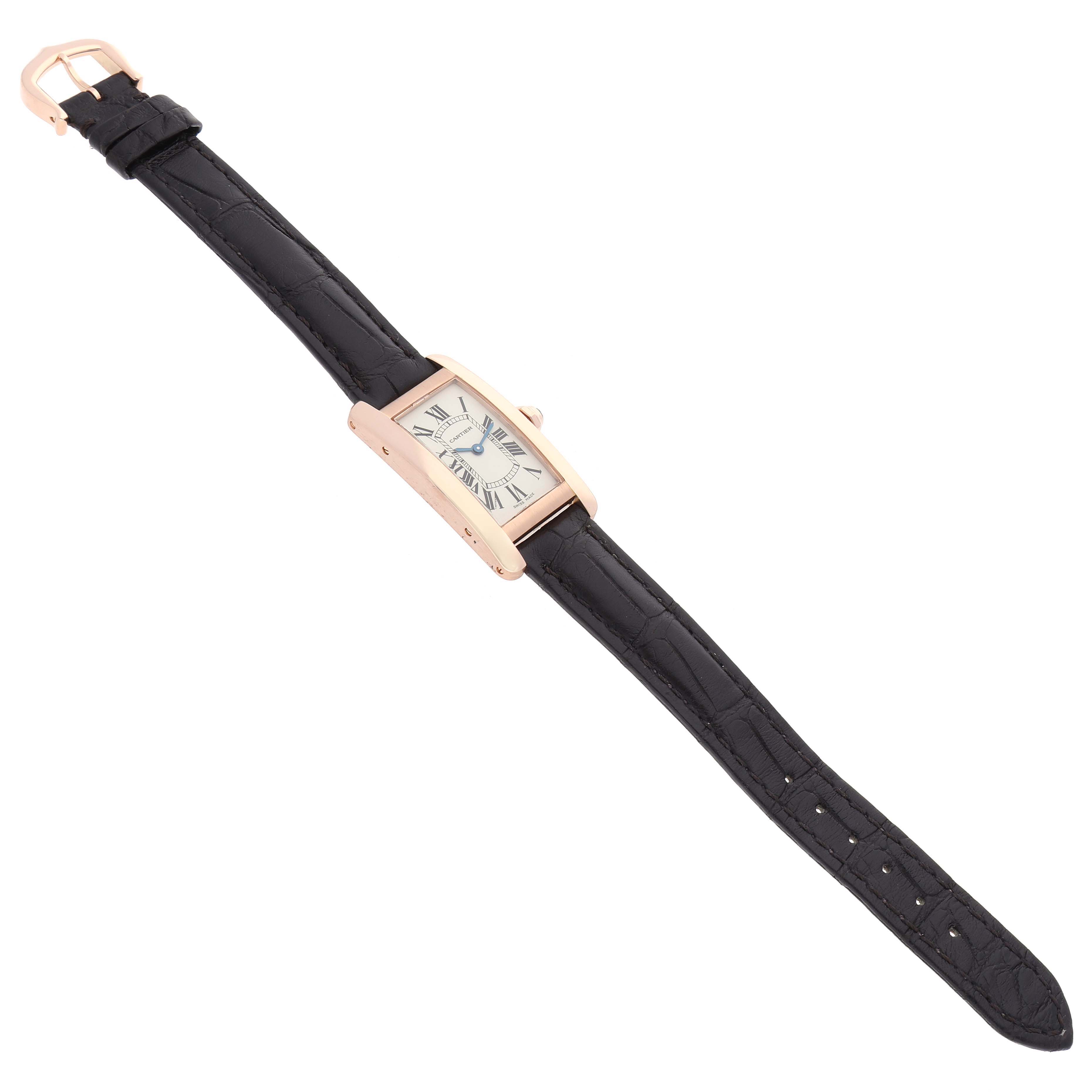The Cartier Tank Americaine W2607456 Women's Rose Gold Silver Dial W2607456 Women's Rose Gold Silver Dial watch is shown from a top angle, displaying the face, rose gold case, and black leather strap.