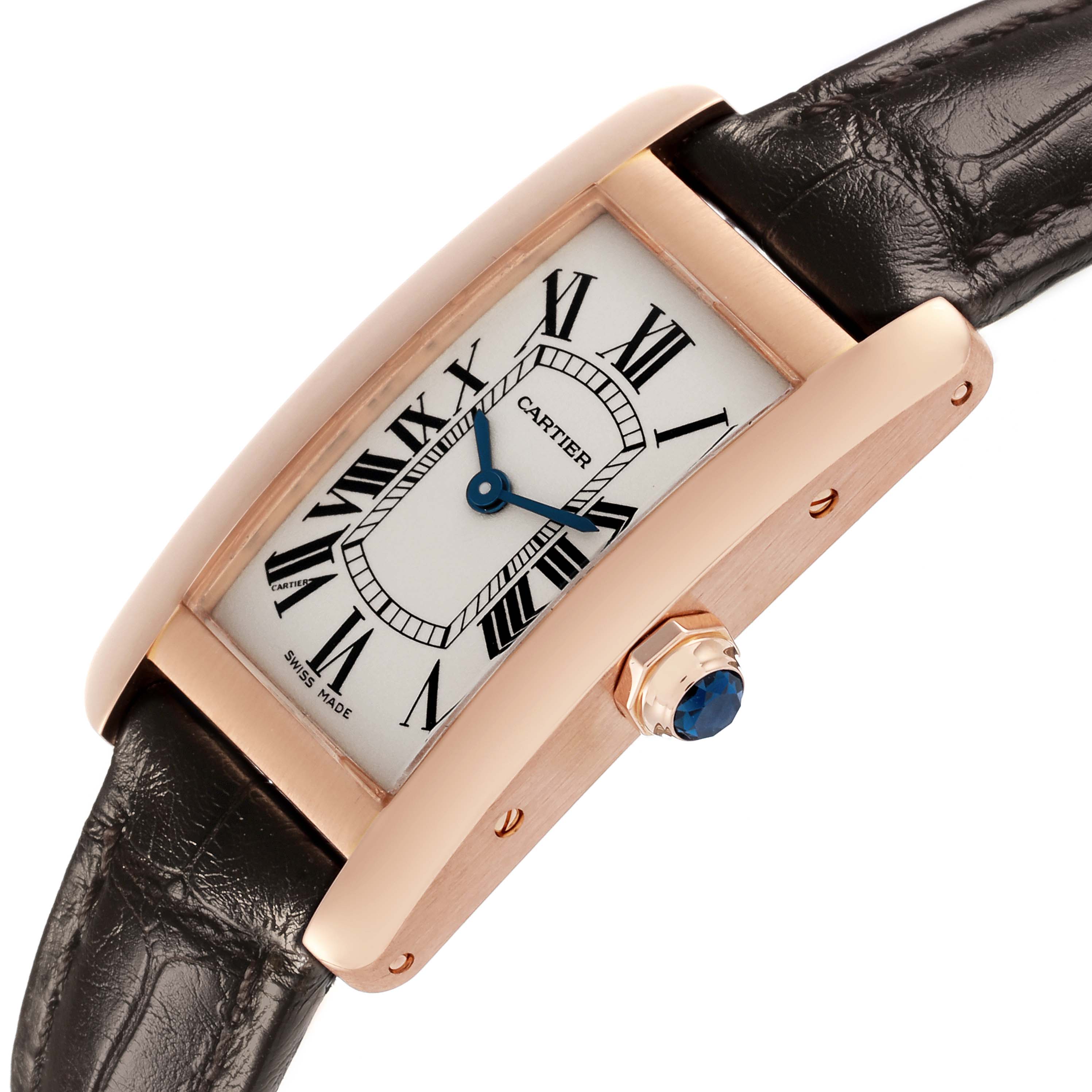 The Cartier Tank Americaine W2607456 Women's Rose Gold Silver Dial W2607456 Women's Rose Gold Silver Dial watch is shown at an angle displaying the face, Roman numerals, and a leather strap with a side crown.
