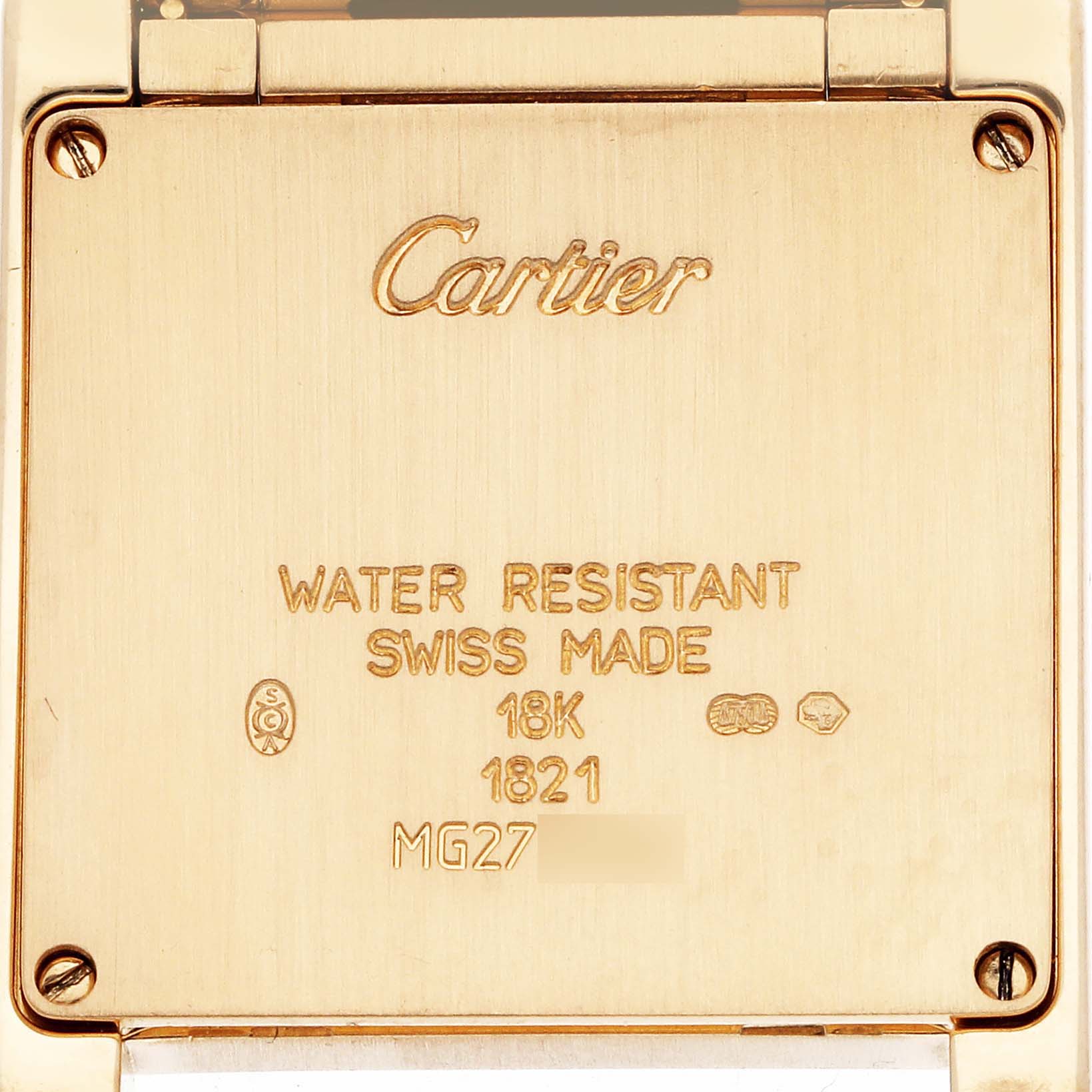 The image shows the back of a Tank Française by Cartier, highlighting its engravings and screws.