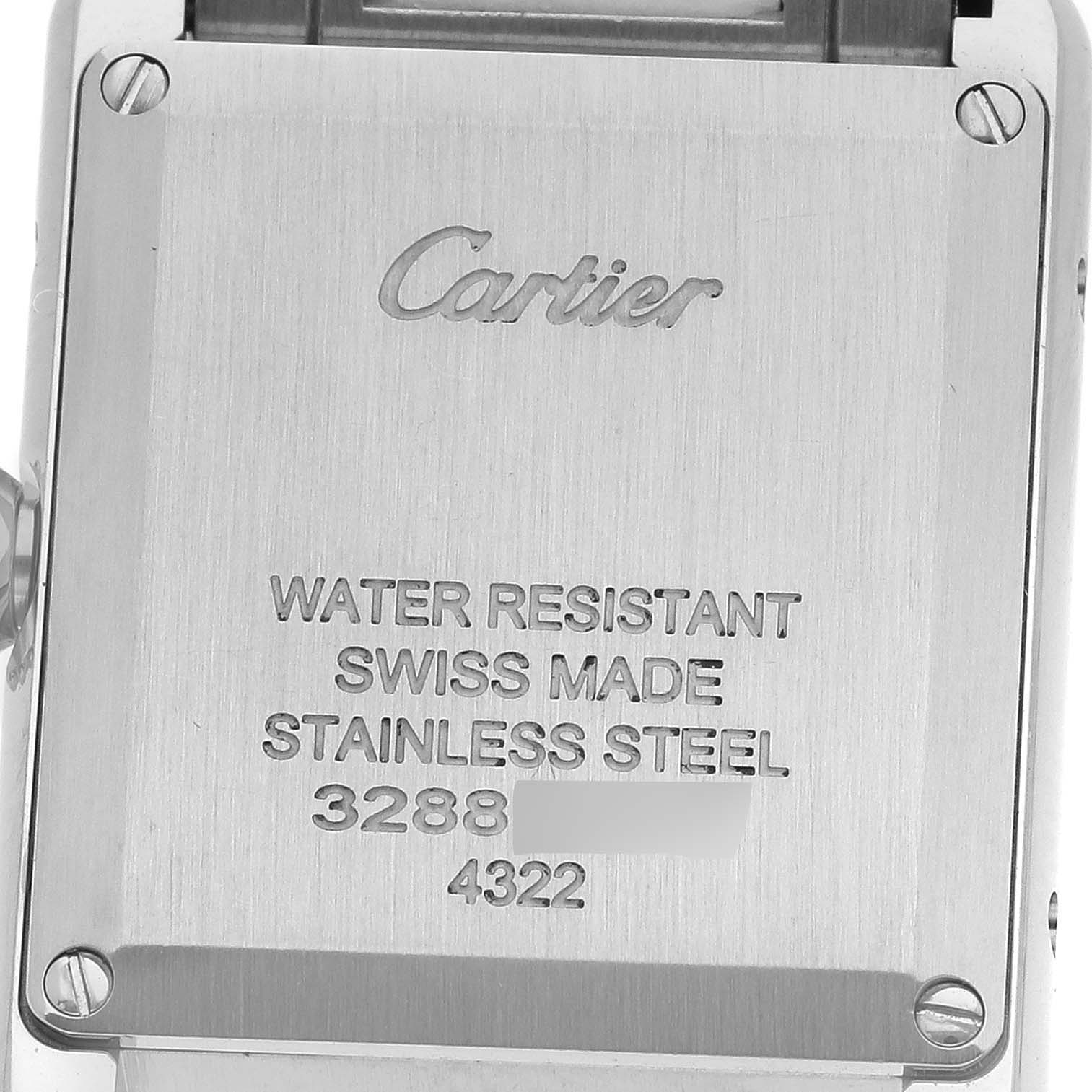 The image shows the back casing of a Cartier Tank Must WSTA0051 Women's Stainless Steel Silver Dial WSTA0051 Women's Stainless Steel Silver Dial watch, highlighting its brand and specifications.