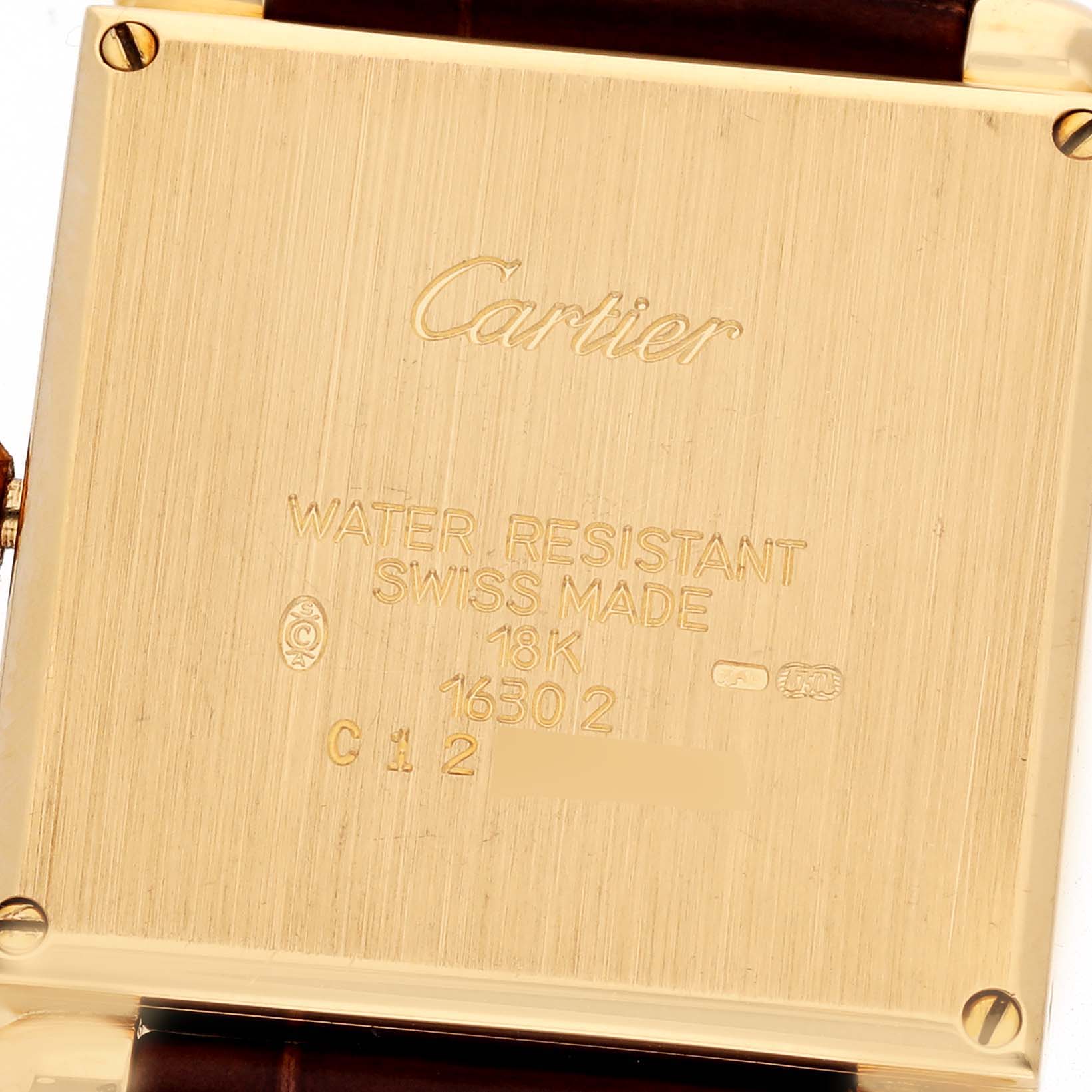 The image shows the back case of the Cartier Tank Obus W1512256 Women's Yellow Gold Silver Dial W1512256 Women's Yellow Gold Silver Dial watch, with inscriptions and leather straps visible.