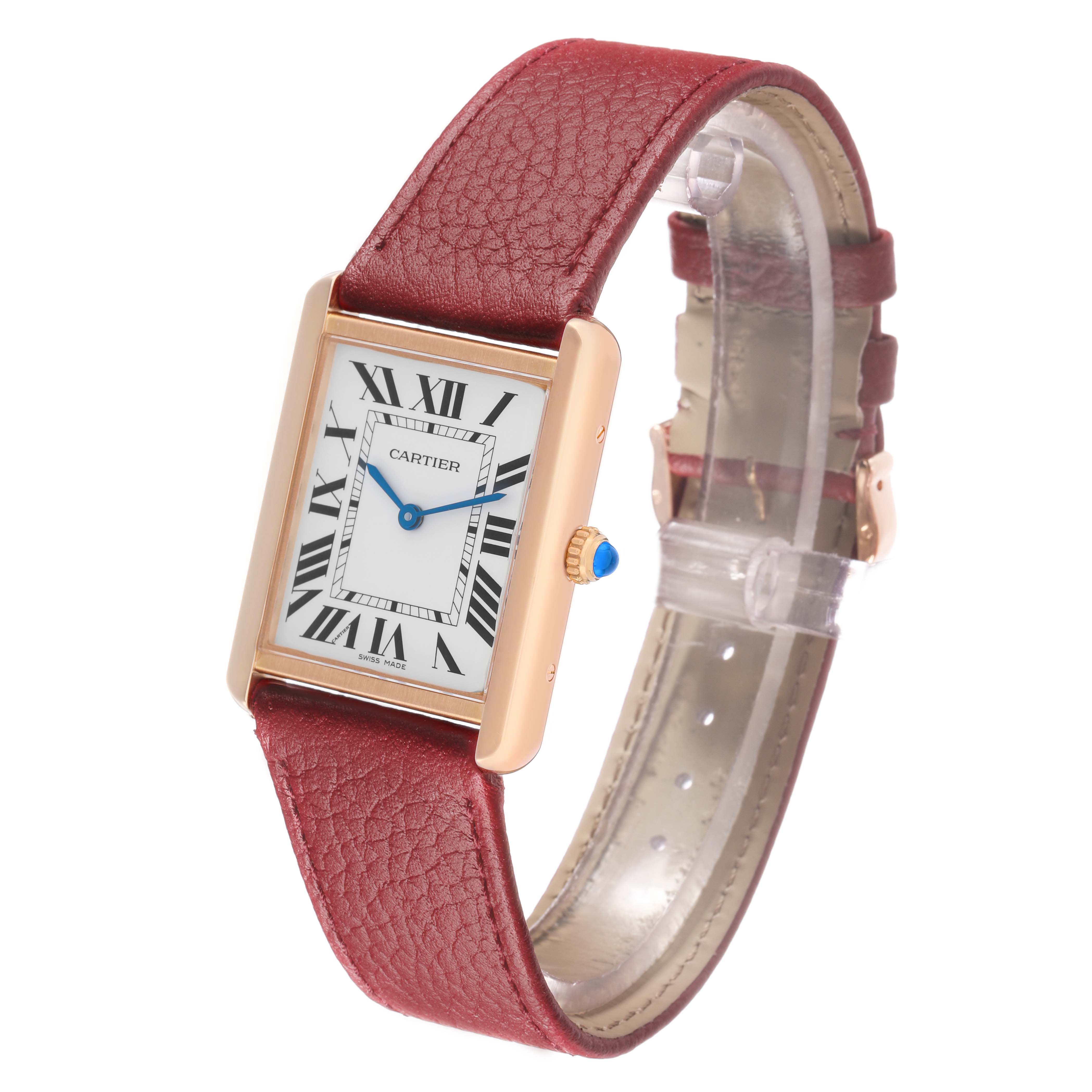 The Cartier Tank Solo W5200025 Men's Rose Gold Silver Dial watch is shown from a three-quarter view, highlighting the rectangular dial, Roman numerals, and red leather strap.