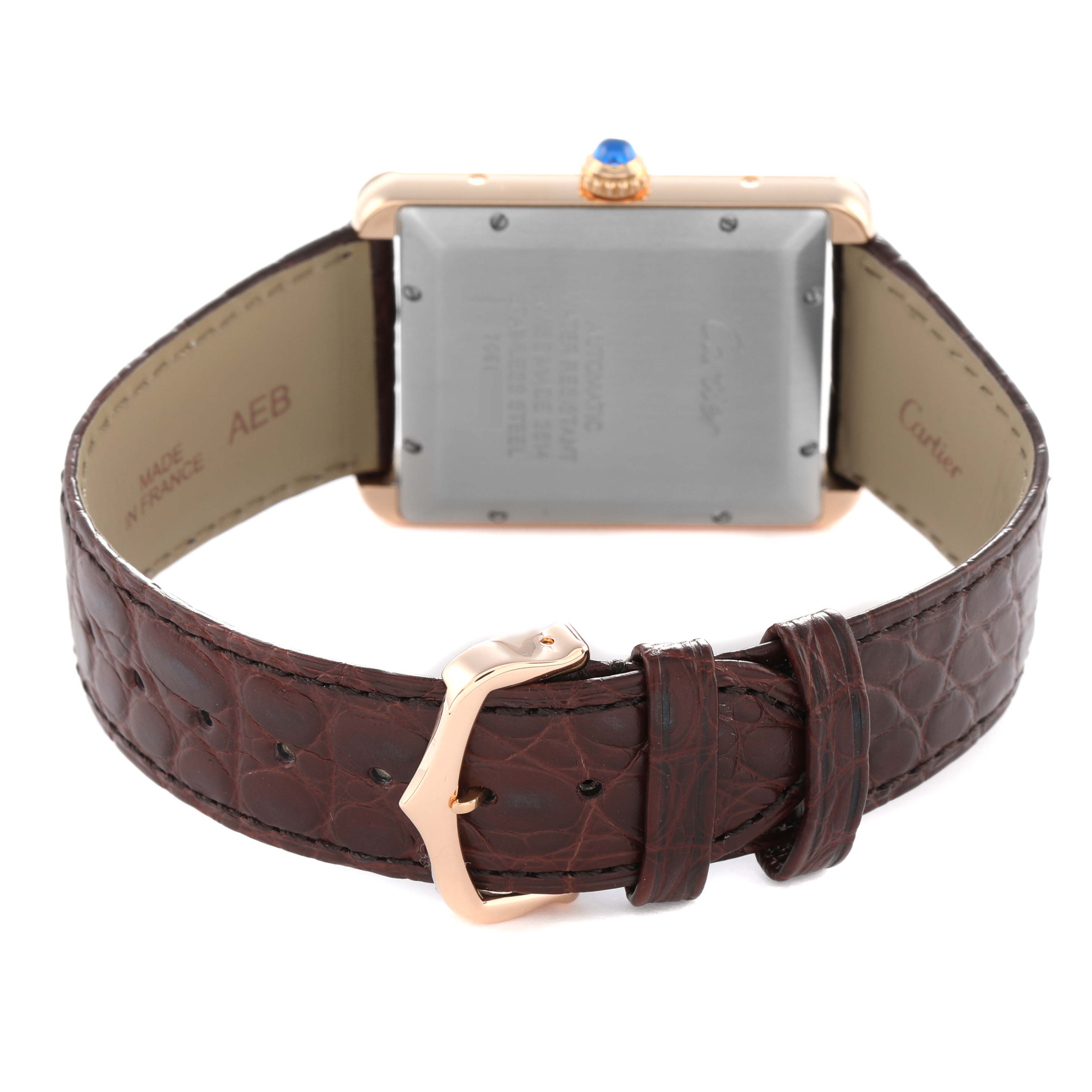 The Cartier Tank Solo W5200026 Men's Rose Gold Silver Dial watch is shown from the back, displaying the case back, crown, and brown leather strap with buckle.