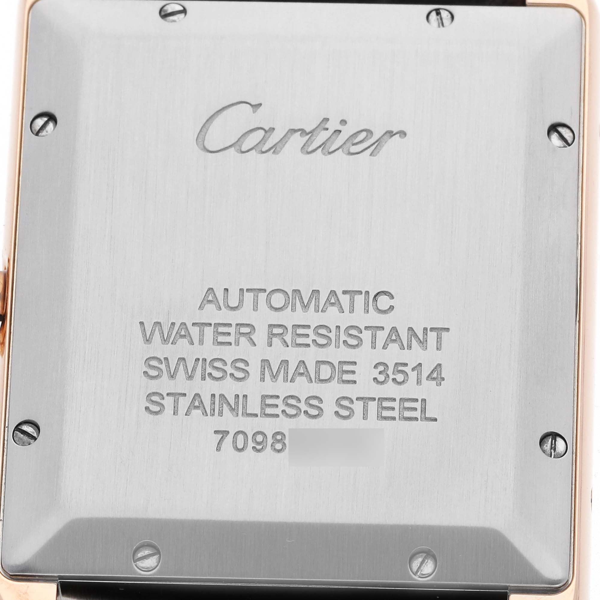 The image shows the back case of the Cartier Tank Solo W5200026 Men's Rose Gold Silver Dial watch, displaying brand and model details engraved on the stainless steel.