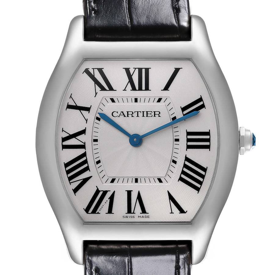 The Cartier Tortue watch is shown from the front, highlighting the dial, Roman numerals, and blue hands.