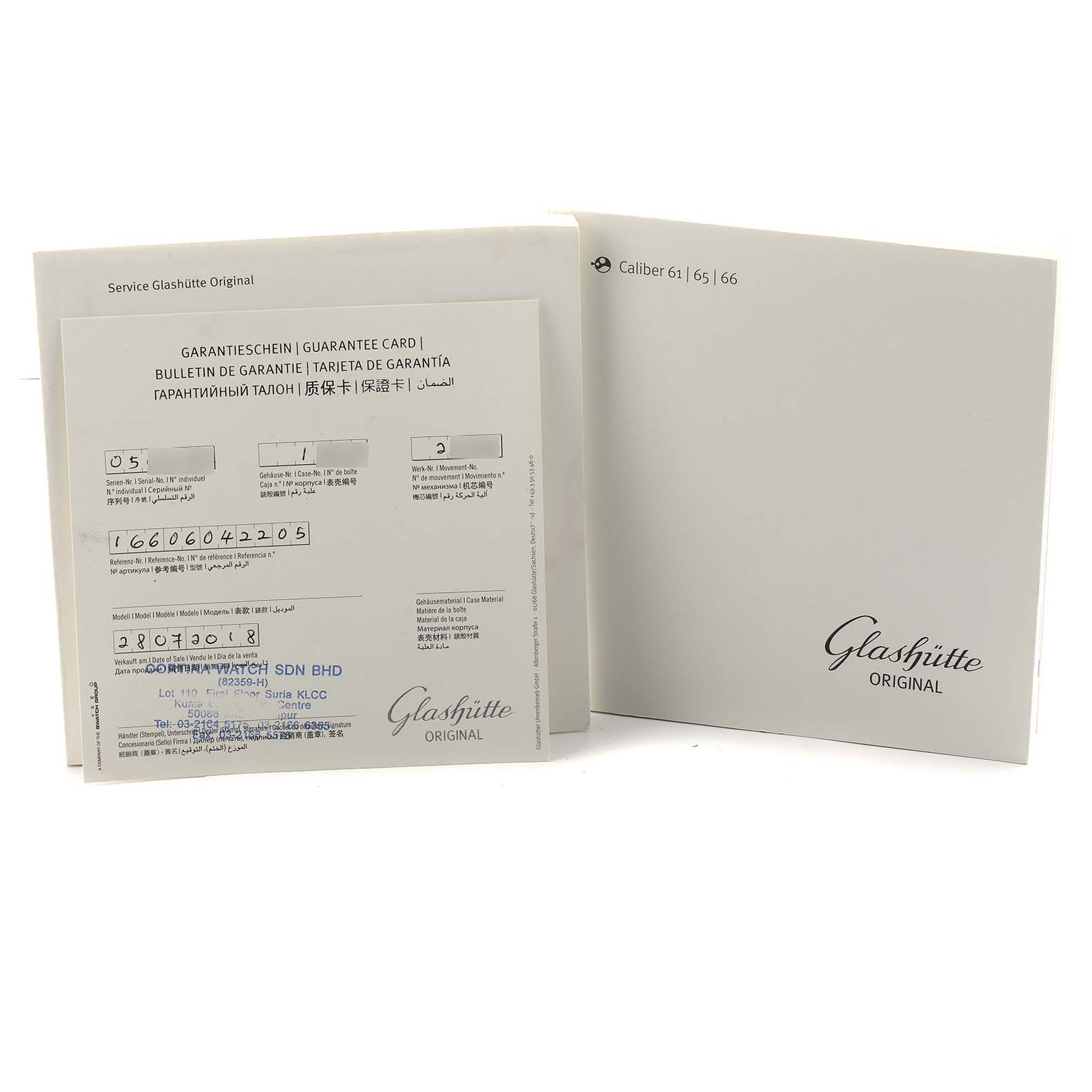 The image shows the Glashütte Original watch's guarantee card and service booklet from a front angle.
