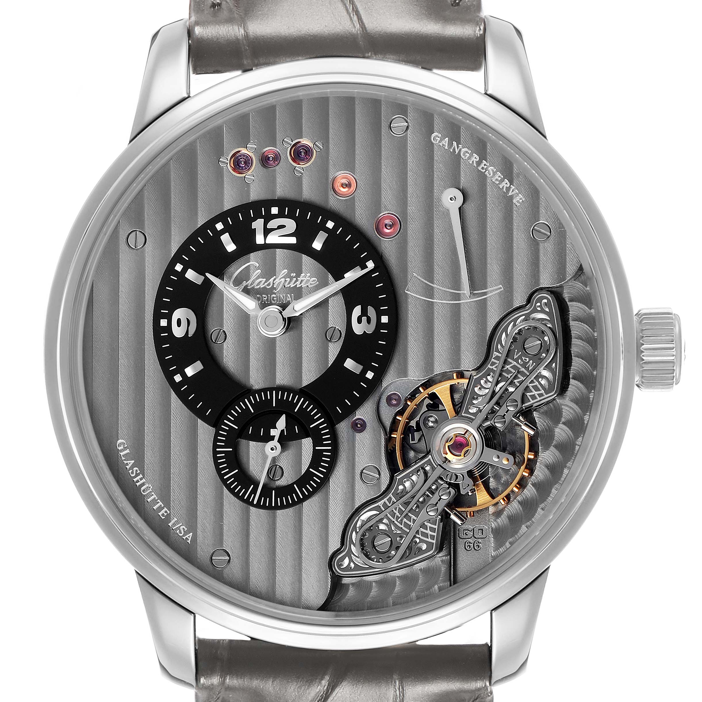 The Glashütte Original watch is shown from the front, featuring its dial, crown, and visible movement details.