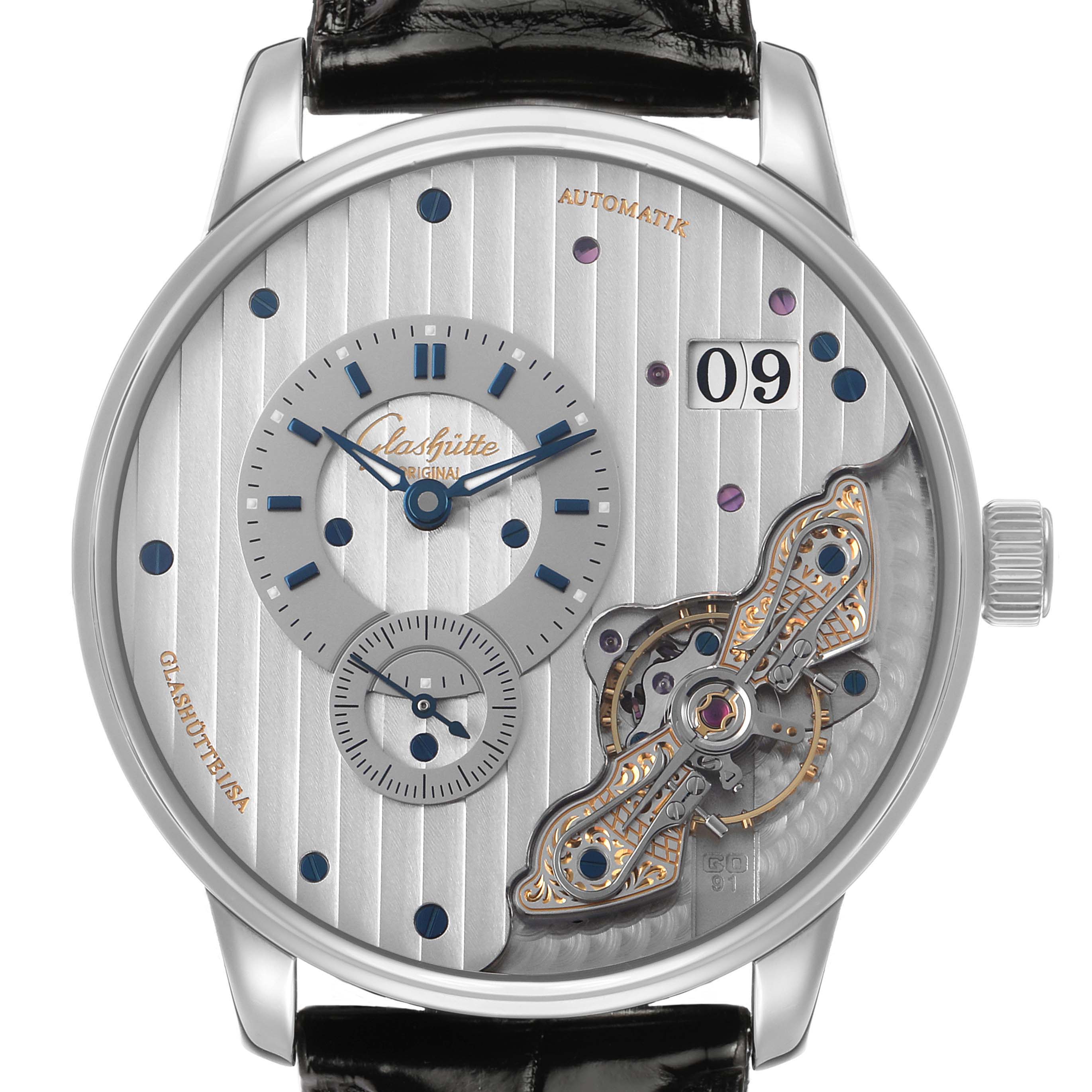 The Glashütte Original watch is shown from the front, highlighting the dial with its time display, date, and intricate mechanisms.