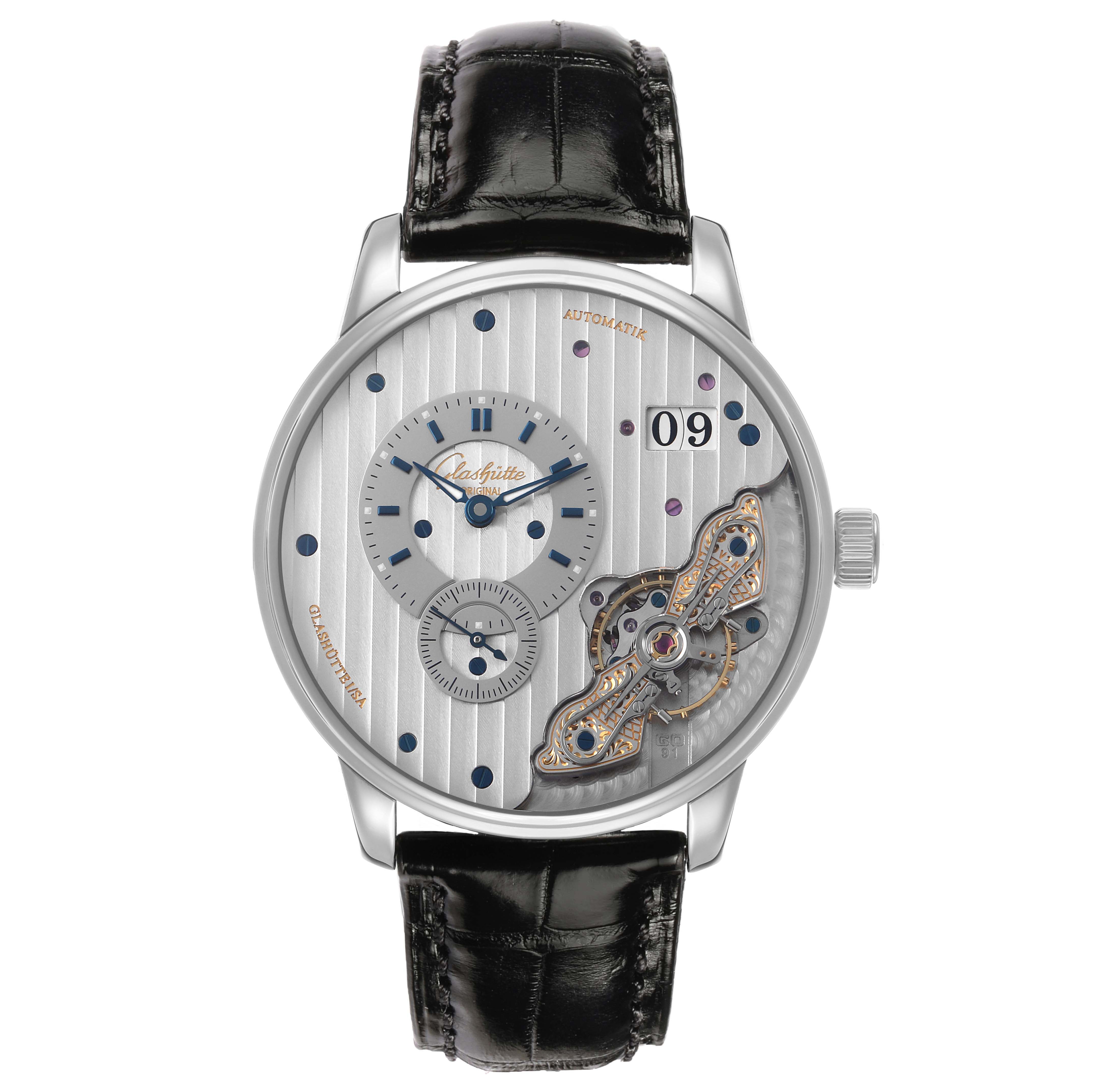 The Glashütte Original model is shown from the front, highlighting the open dial mechanism and black leather strap.